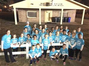 rally of jumpers with blue shirts on taking a group photo