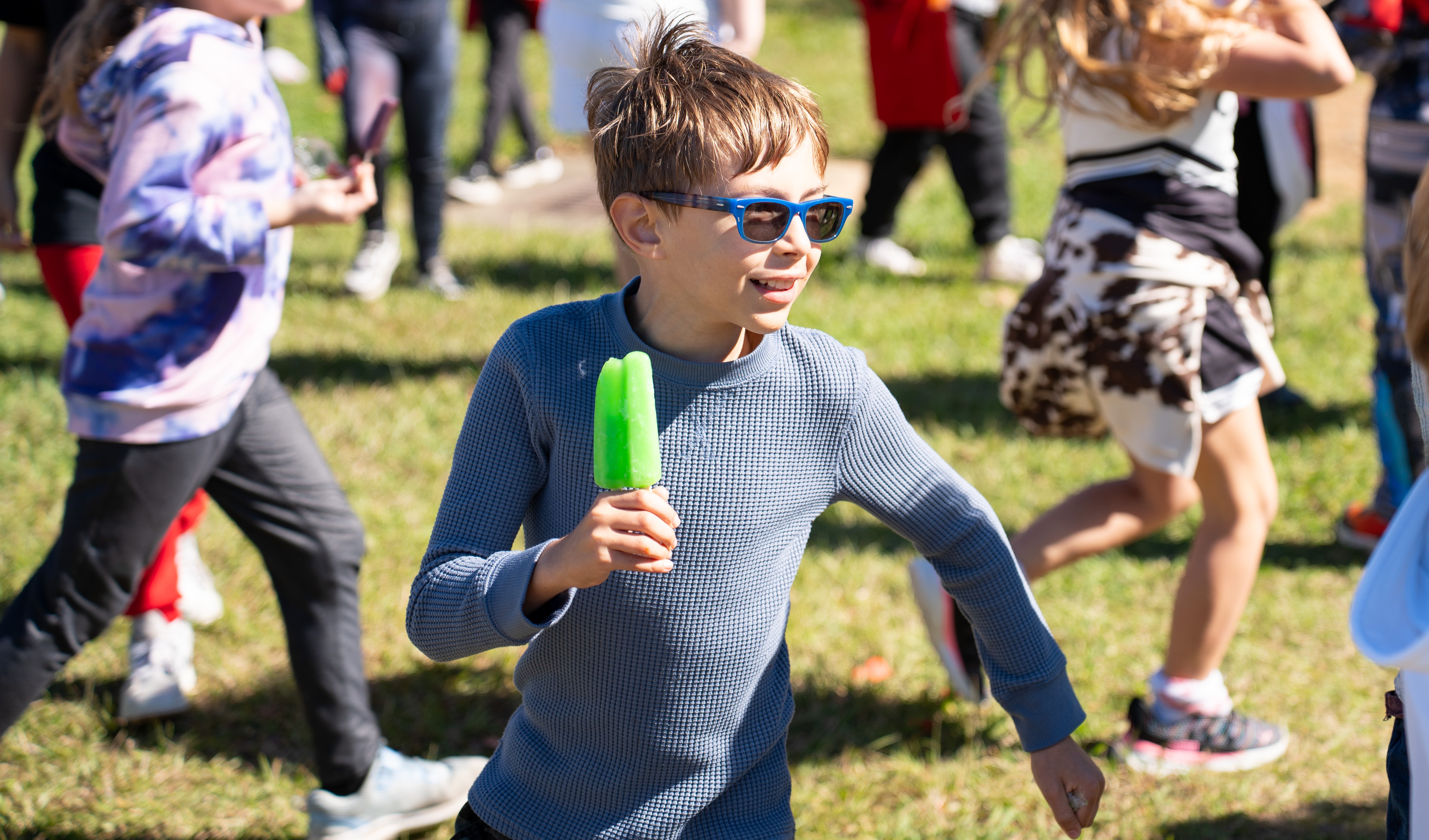 kid running with popsicle