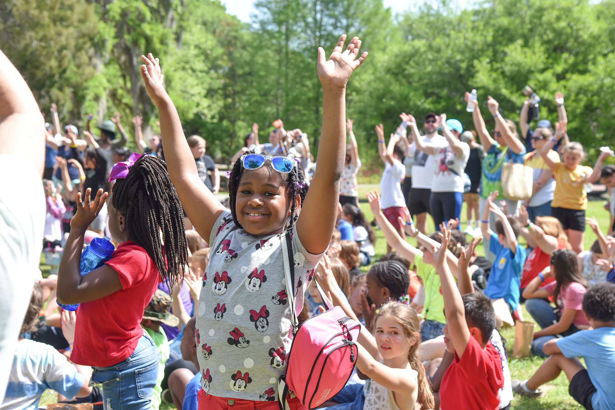 WVE student raising arms in the air