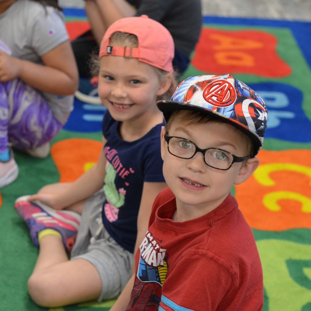 Student smiling on hat day wearing hats