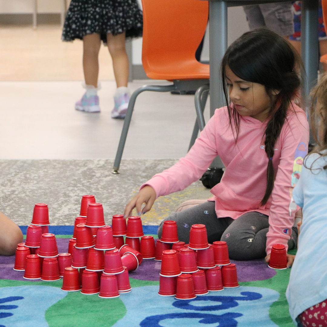 Student playing with mini stack cups