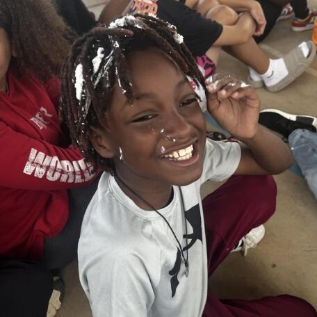 Student with shaving cream on face