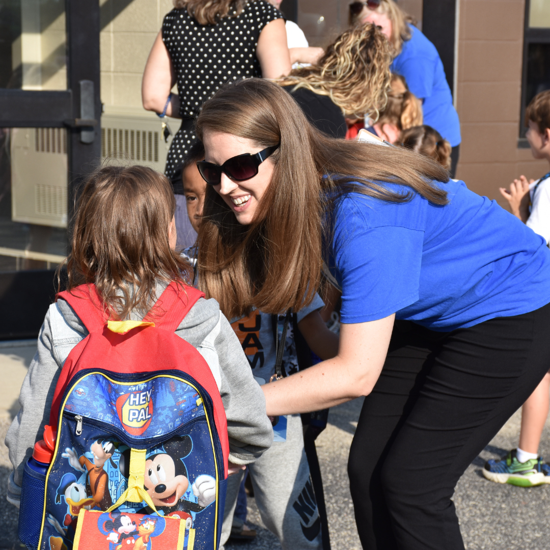 Teacher greeting student