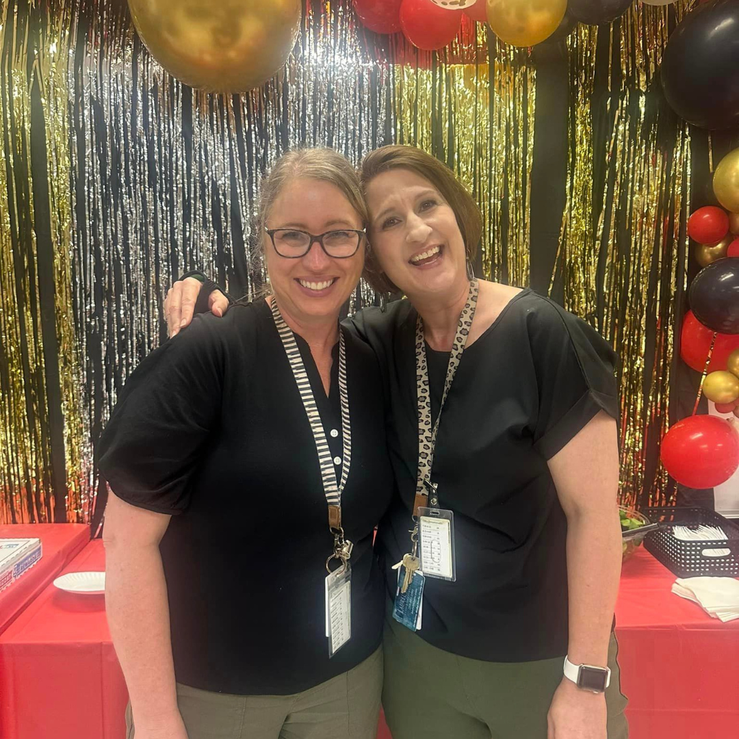 Photo of two staff members smiling