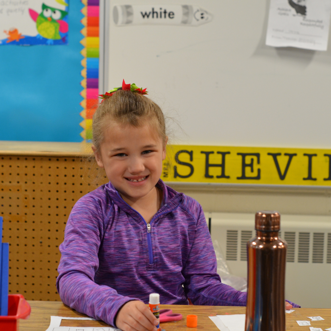 Student smiling while doing work