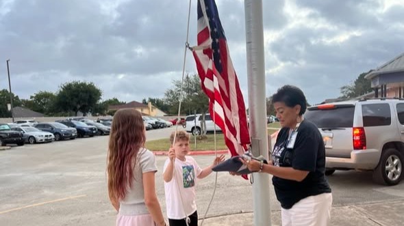 Wilder students raising the flag