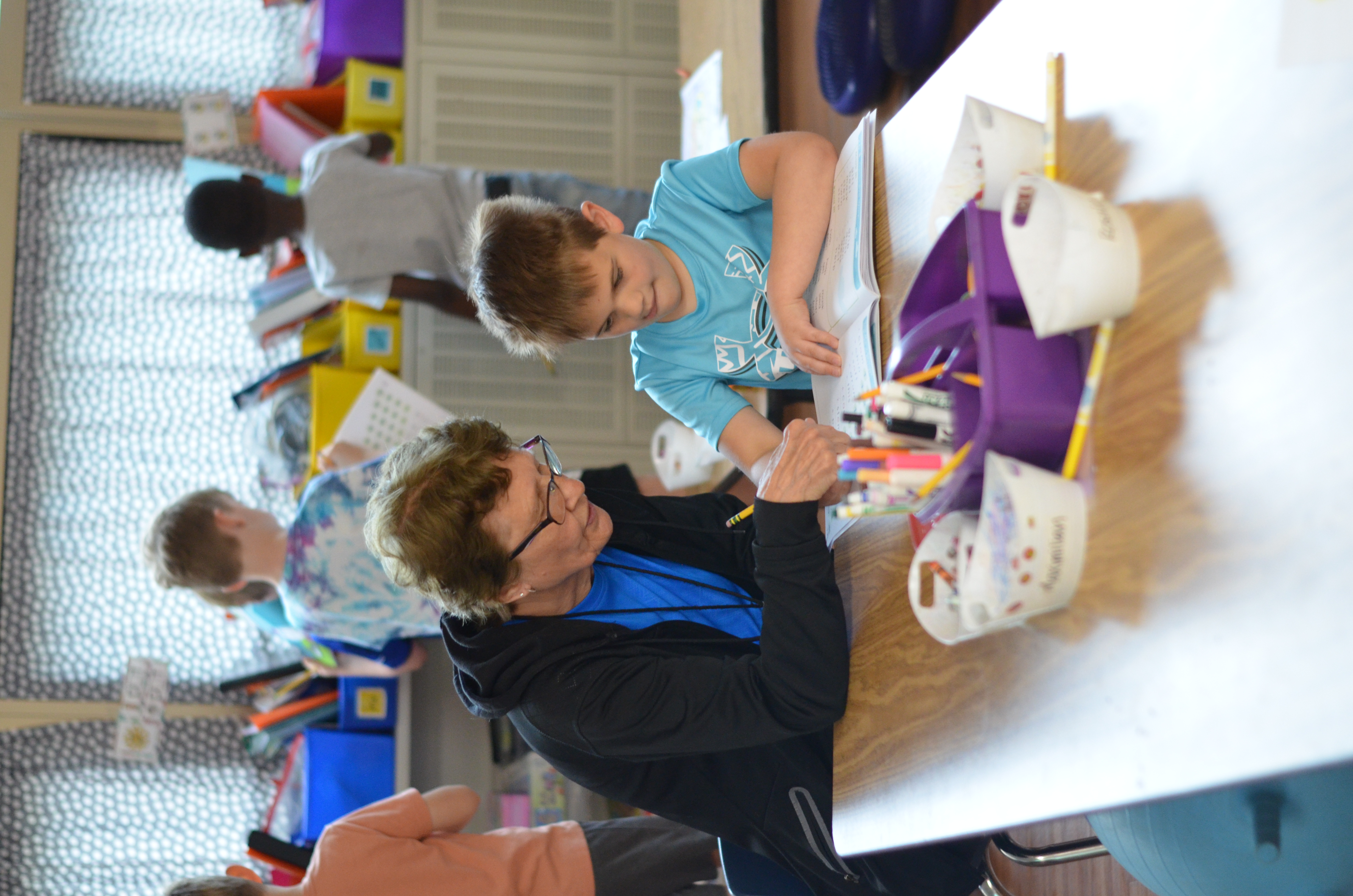 Adult and student reading together