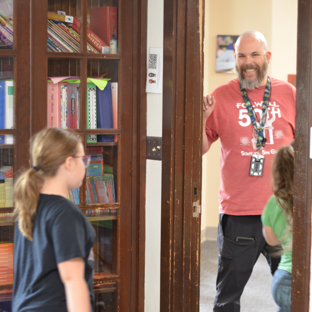 staff smiling at student