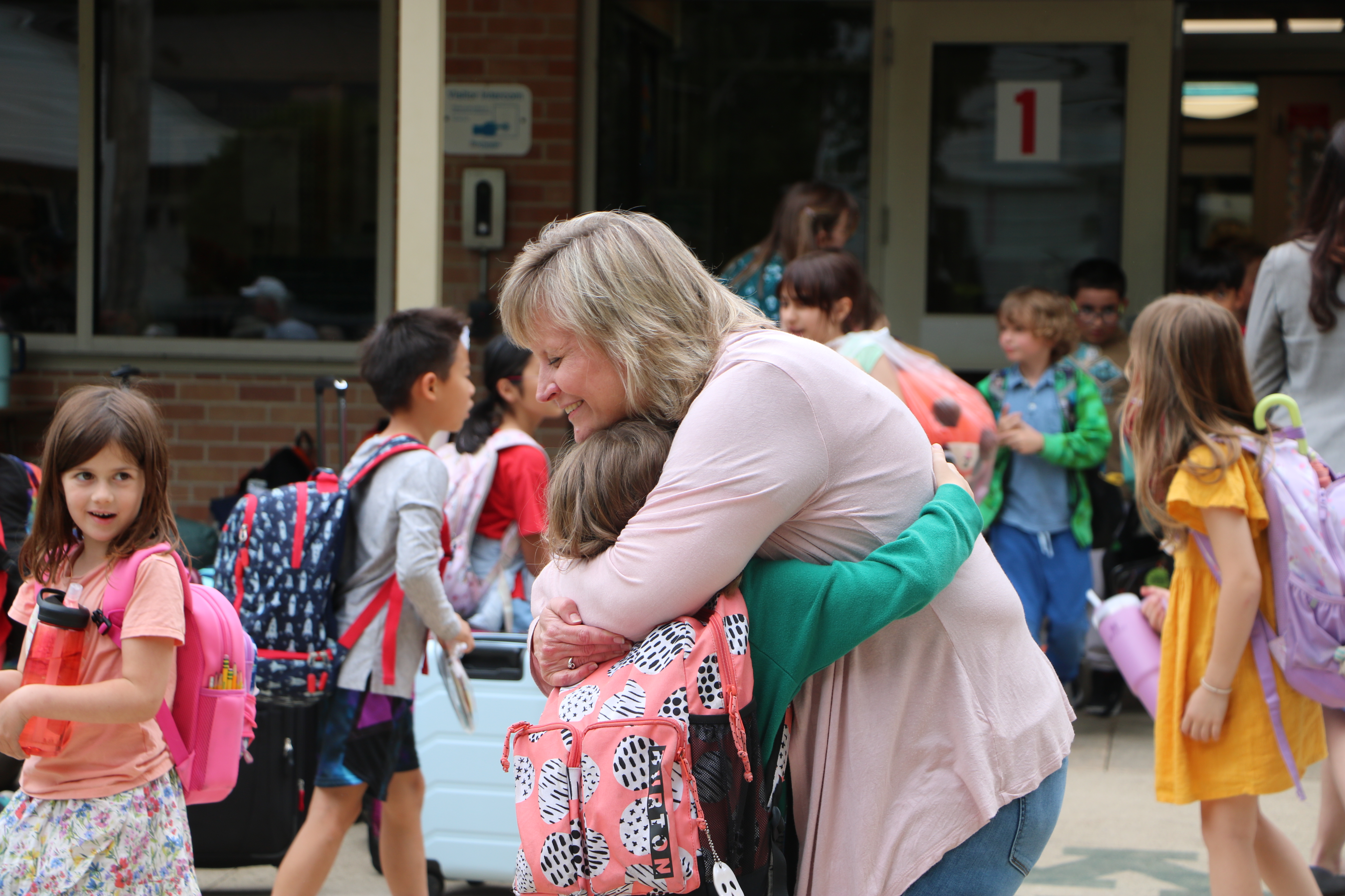Mrs. Smith hugging student