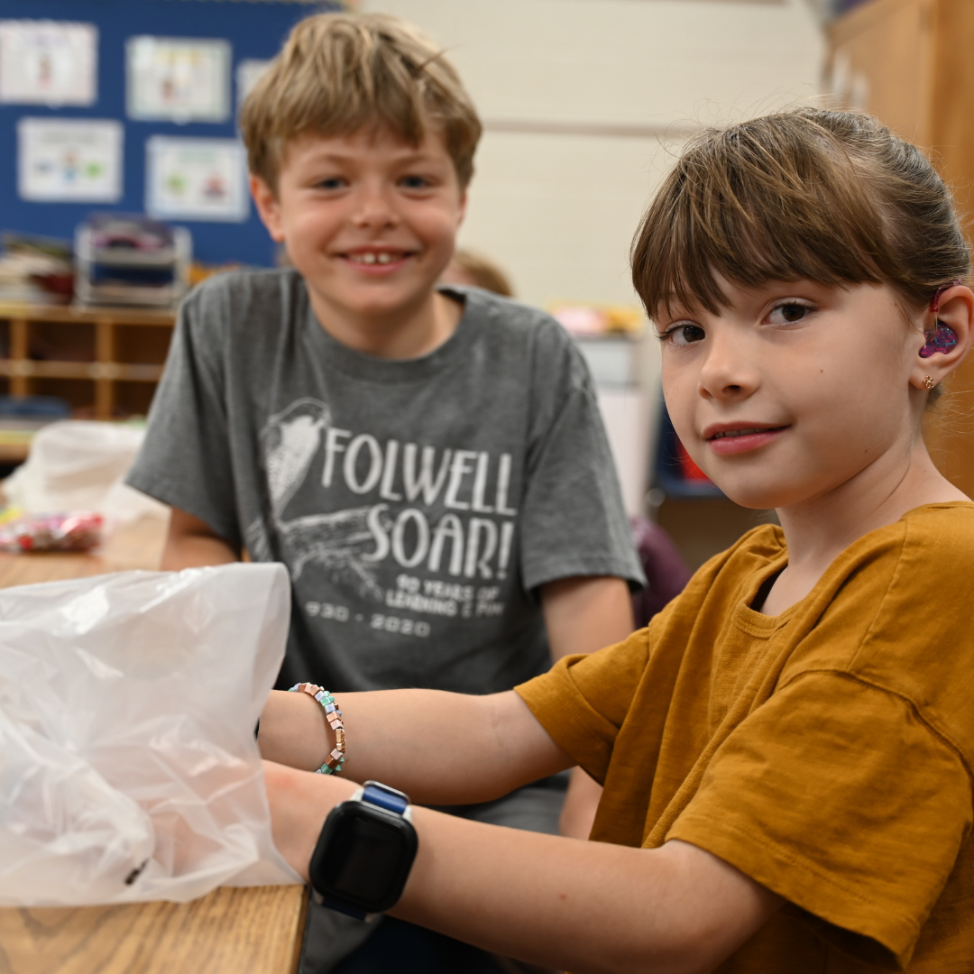 Two students sitting at a desk.
