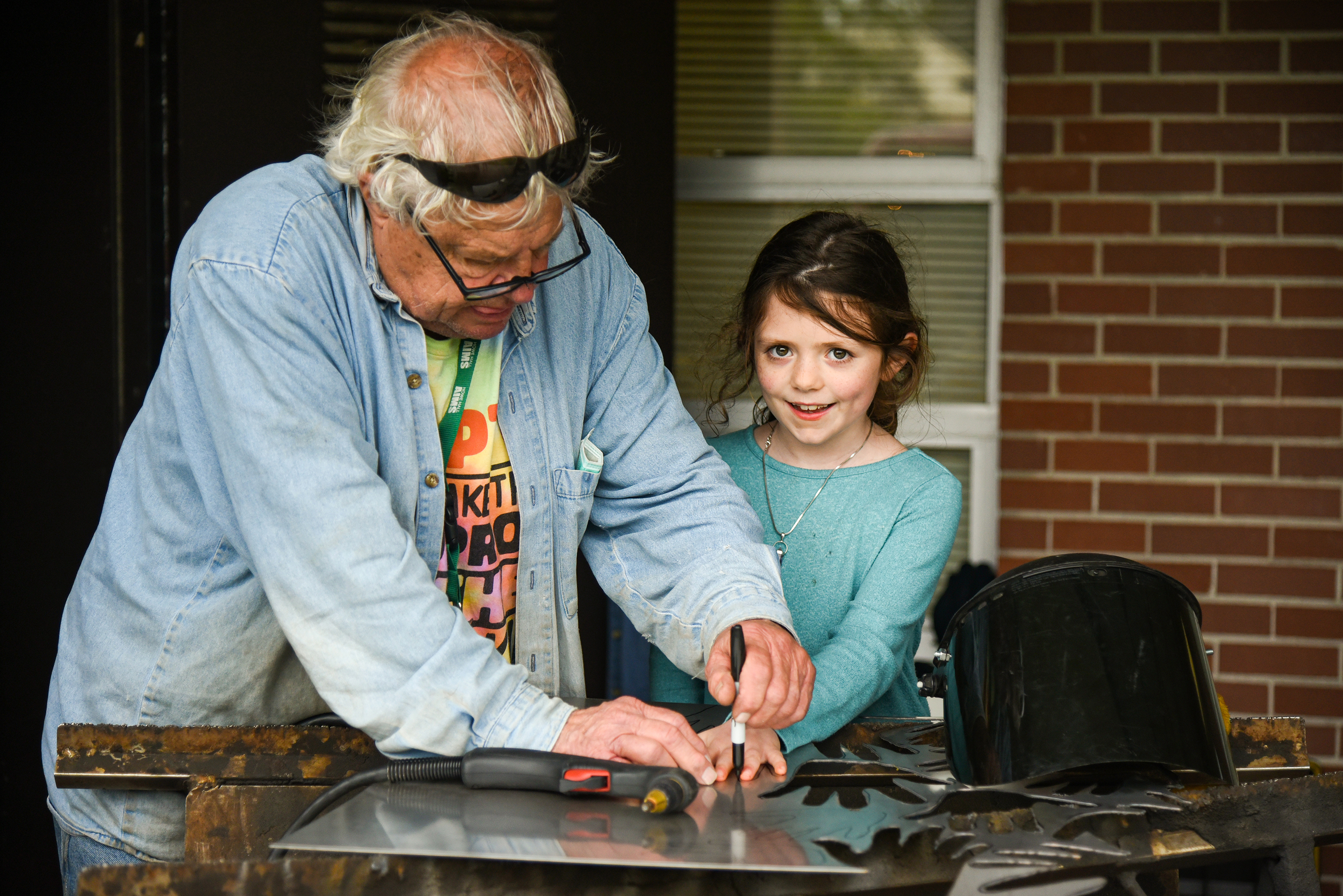 student with welder artist in residence 