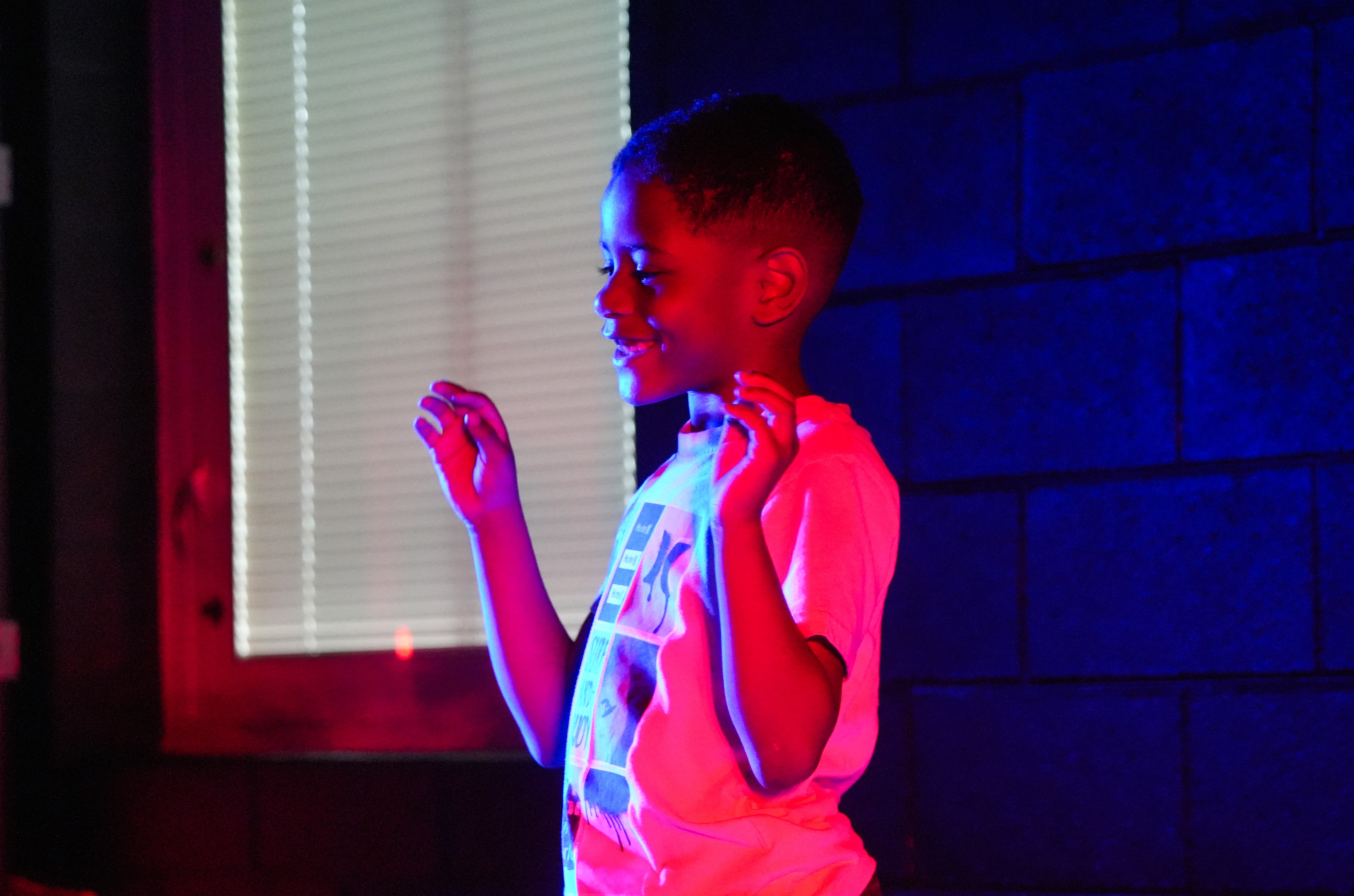 student under red and blue stage lights