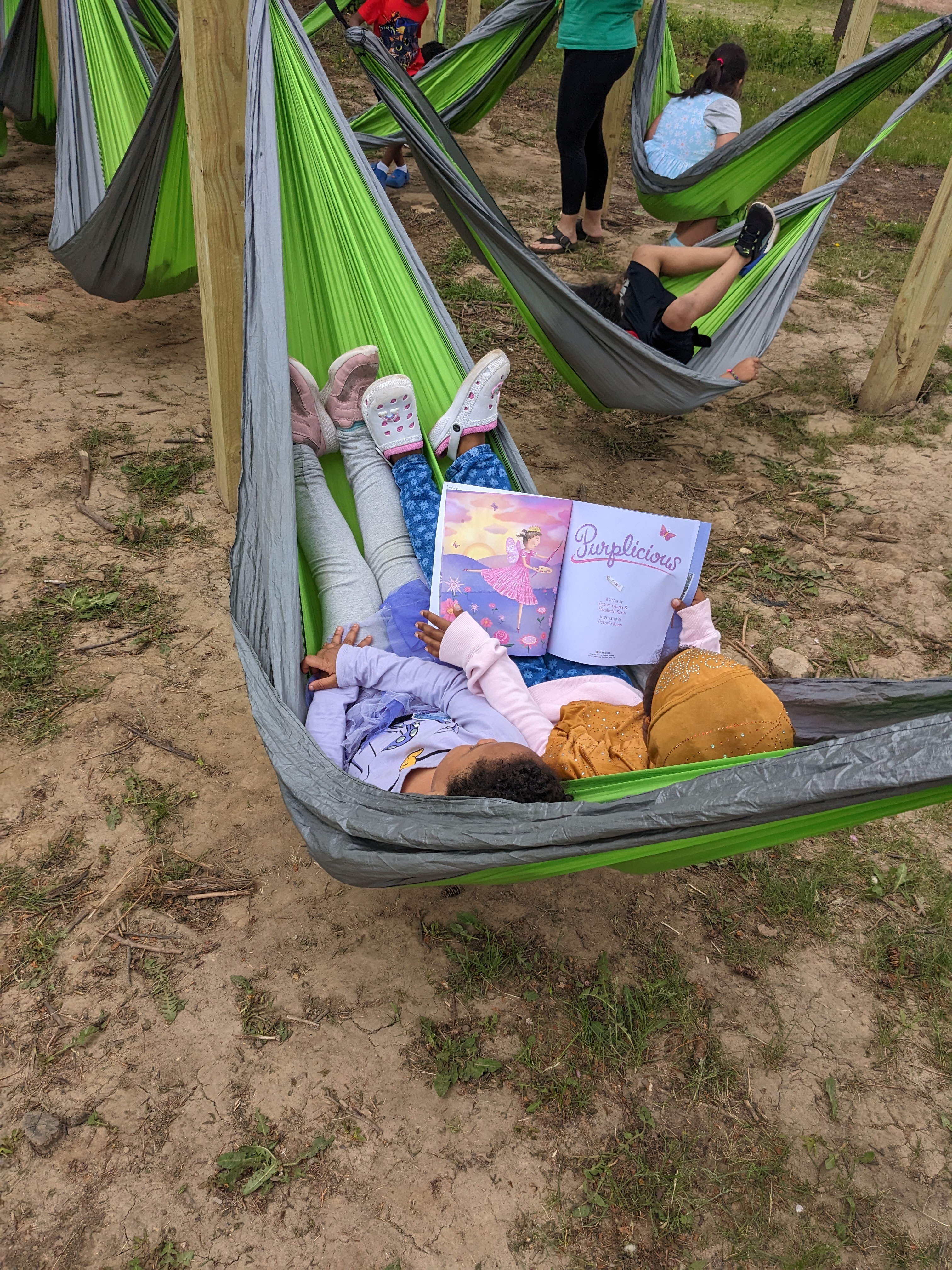 Two students read together in a hammock