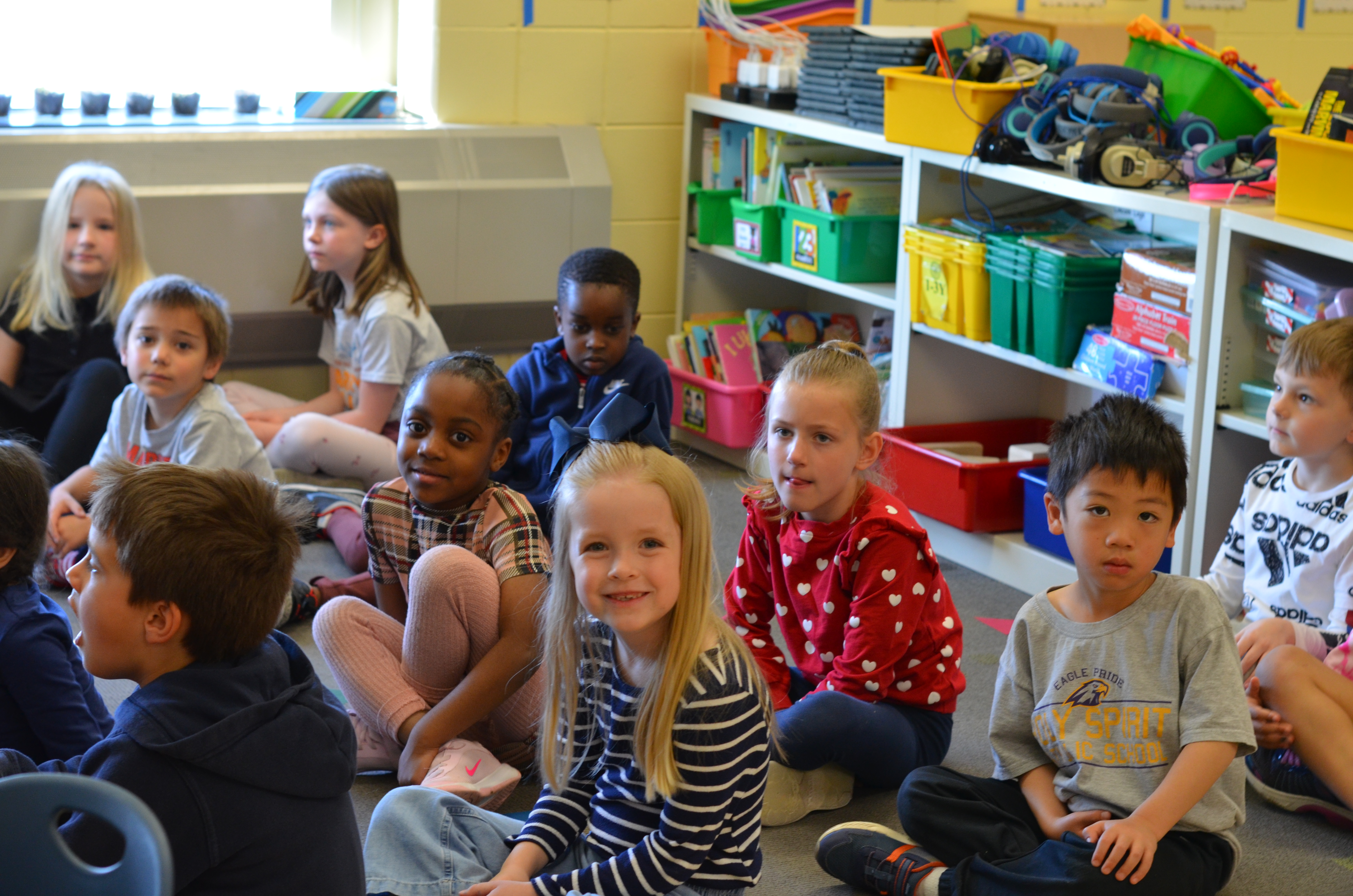 Students sitting on a classroom floor