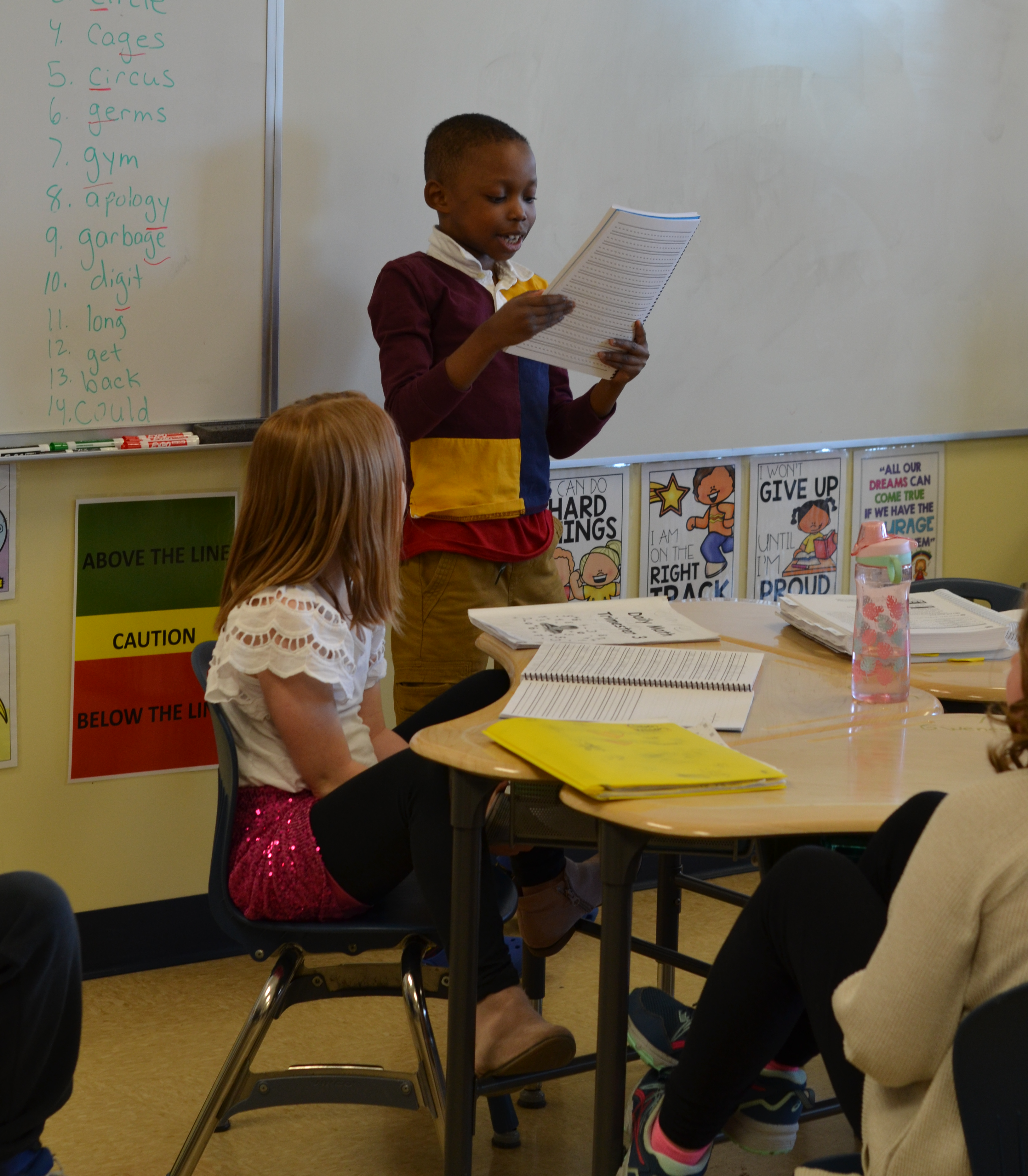 student reading in front of class