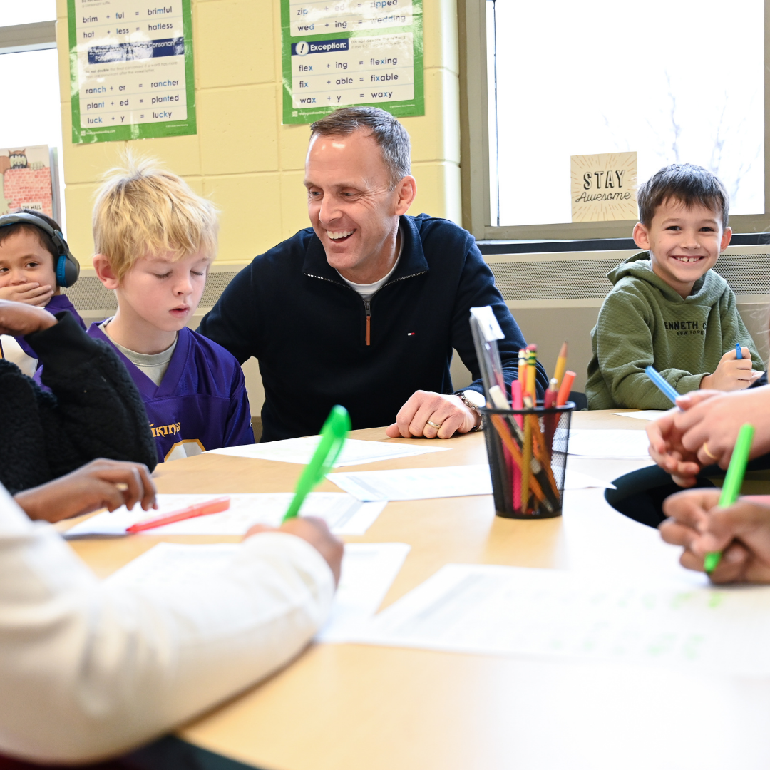 Principal Randall working with students in small groups
