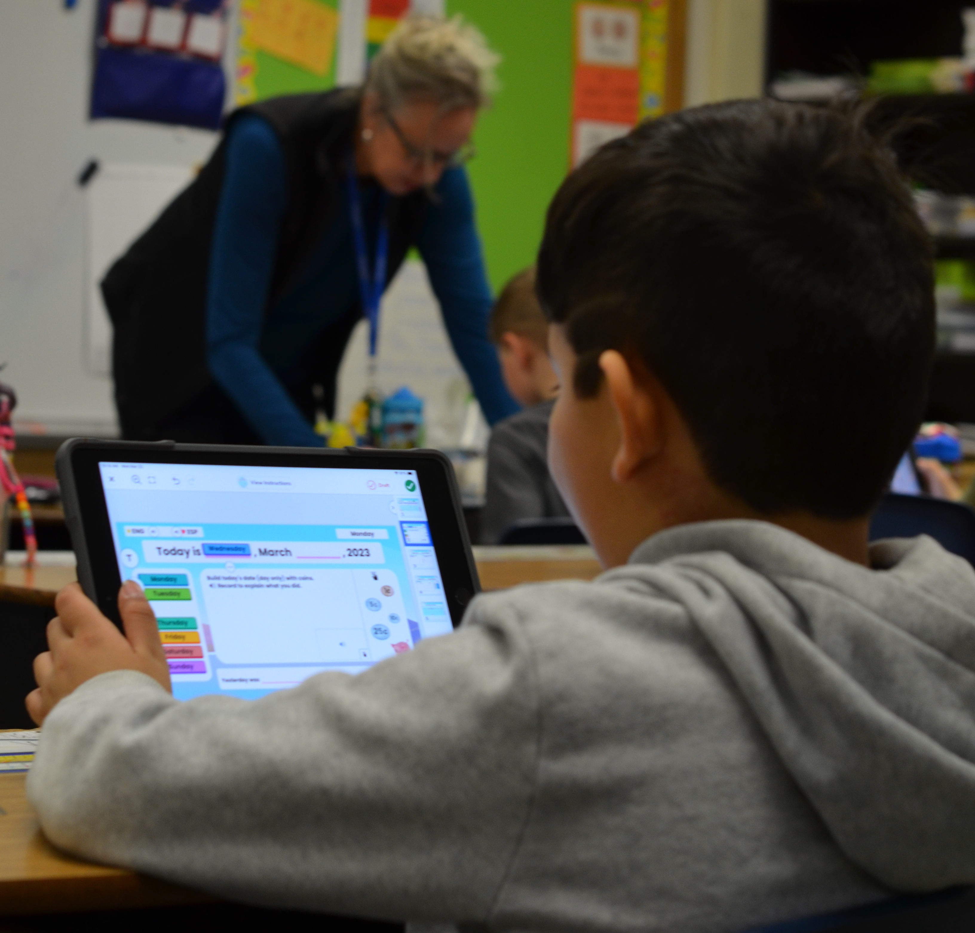 student working on ipad at desk