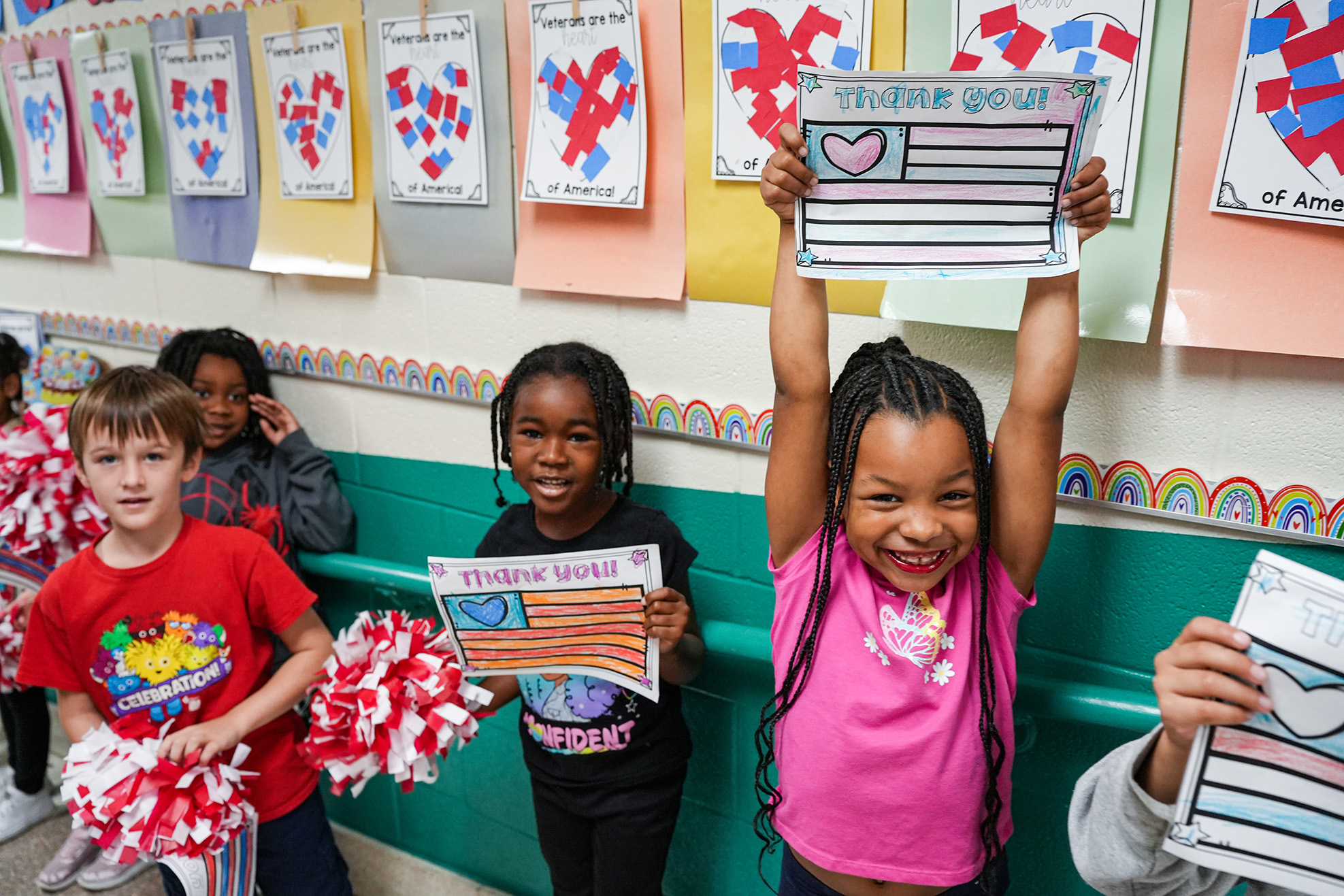 kids holding up veterans day signs