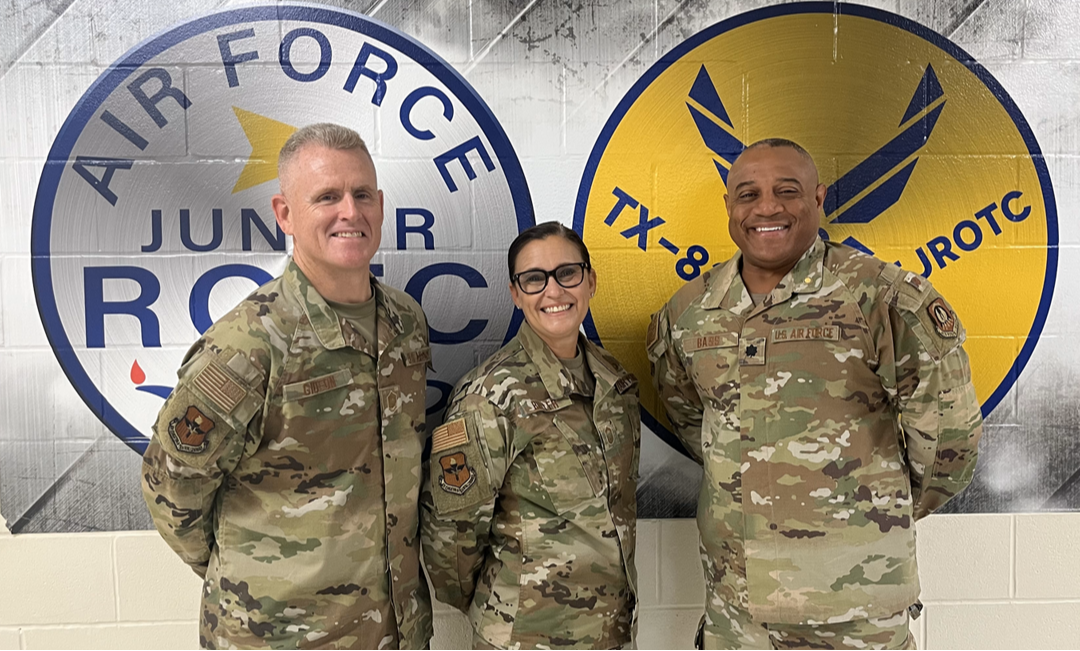 image of 3 afjrotc instructors wearing camouflage usaf uniforms  standing before a mural of afjrotc & tx-82nd emblems