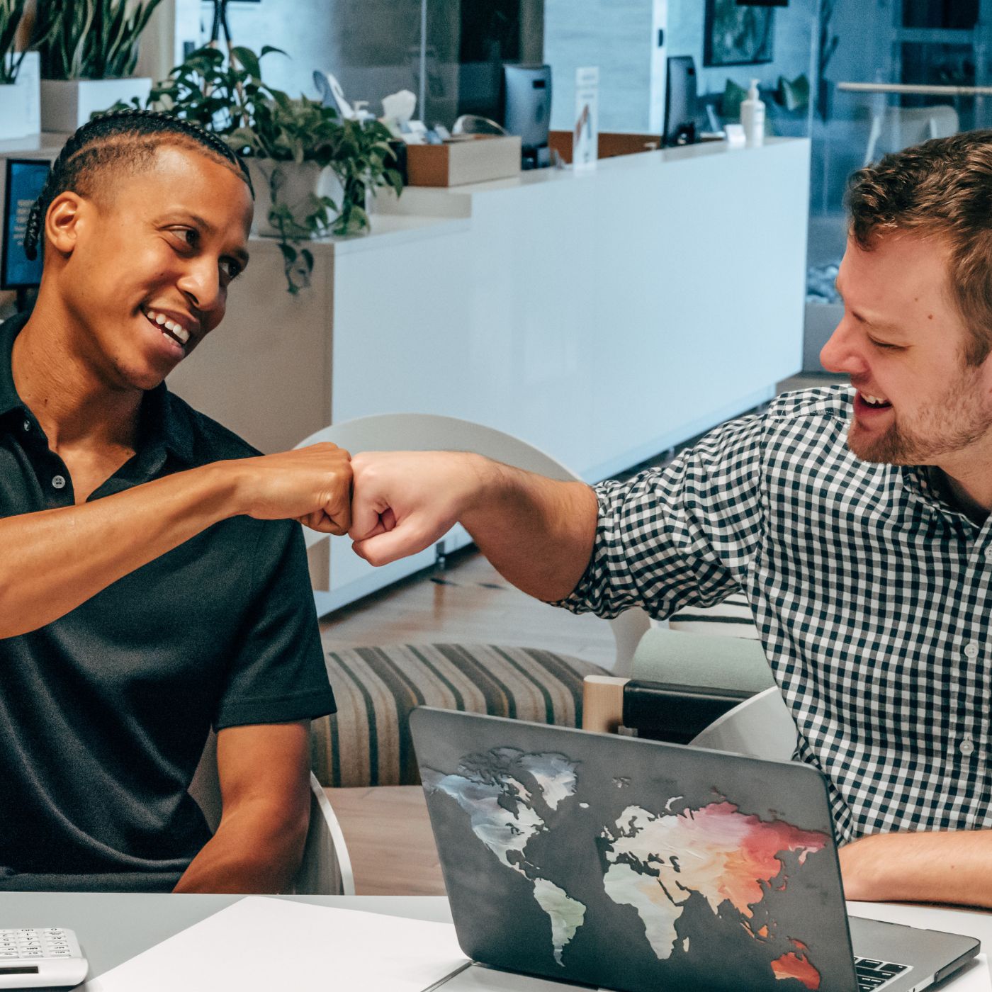 Two diverse men fist bumping