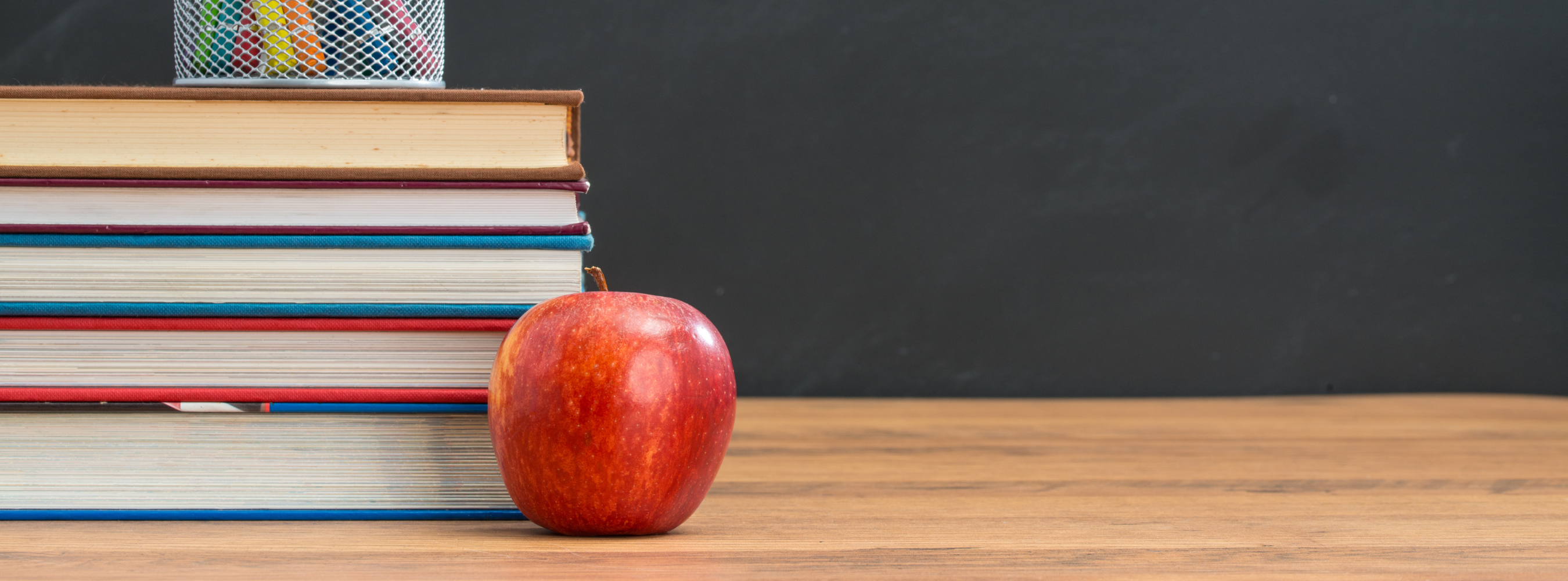 Apple with books on a desk