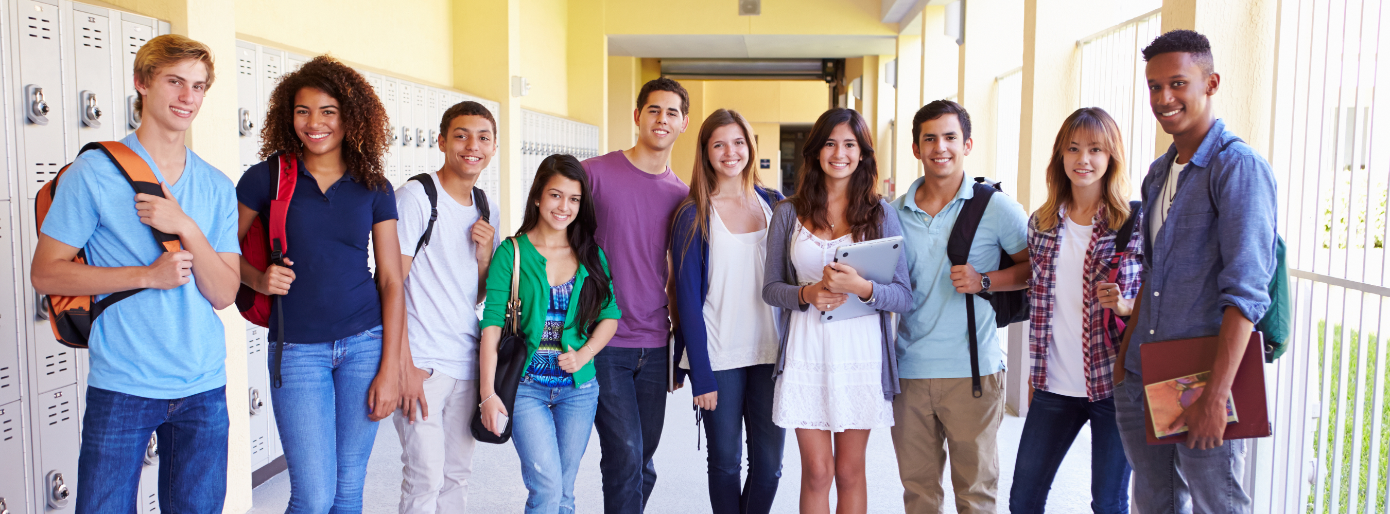 Diverse high school students standing in a high school hallway