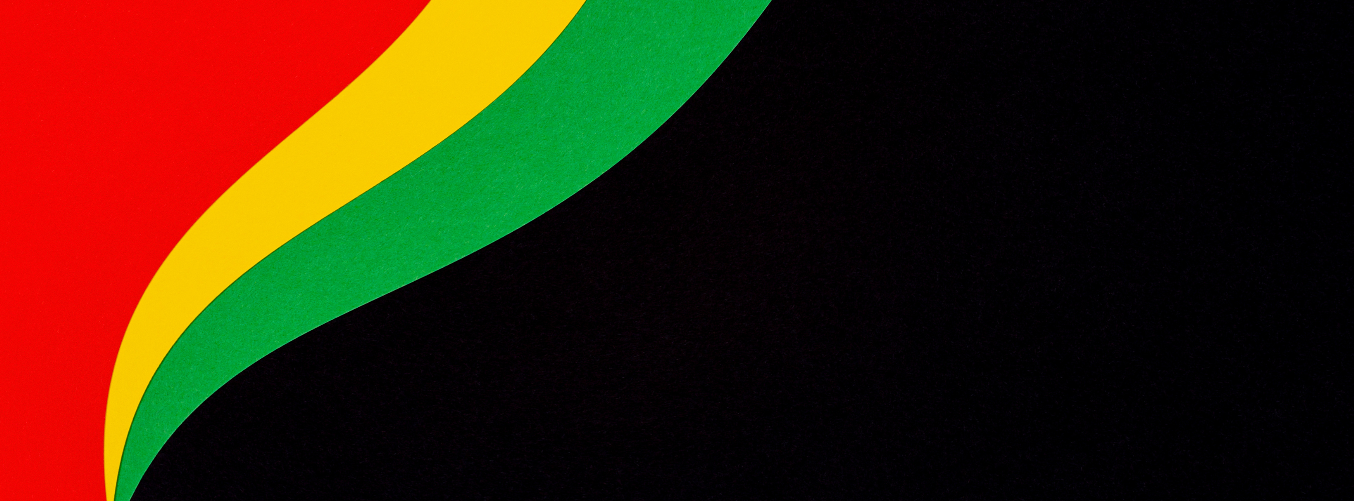 Arches in multiple colors in a corner with a black background