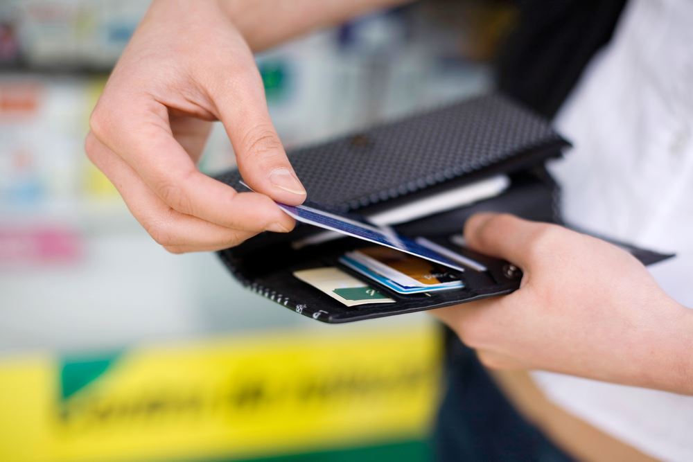 hand pulling a card out of a wallet