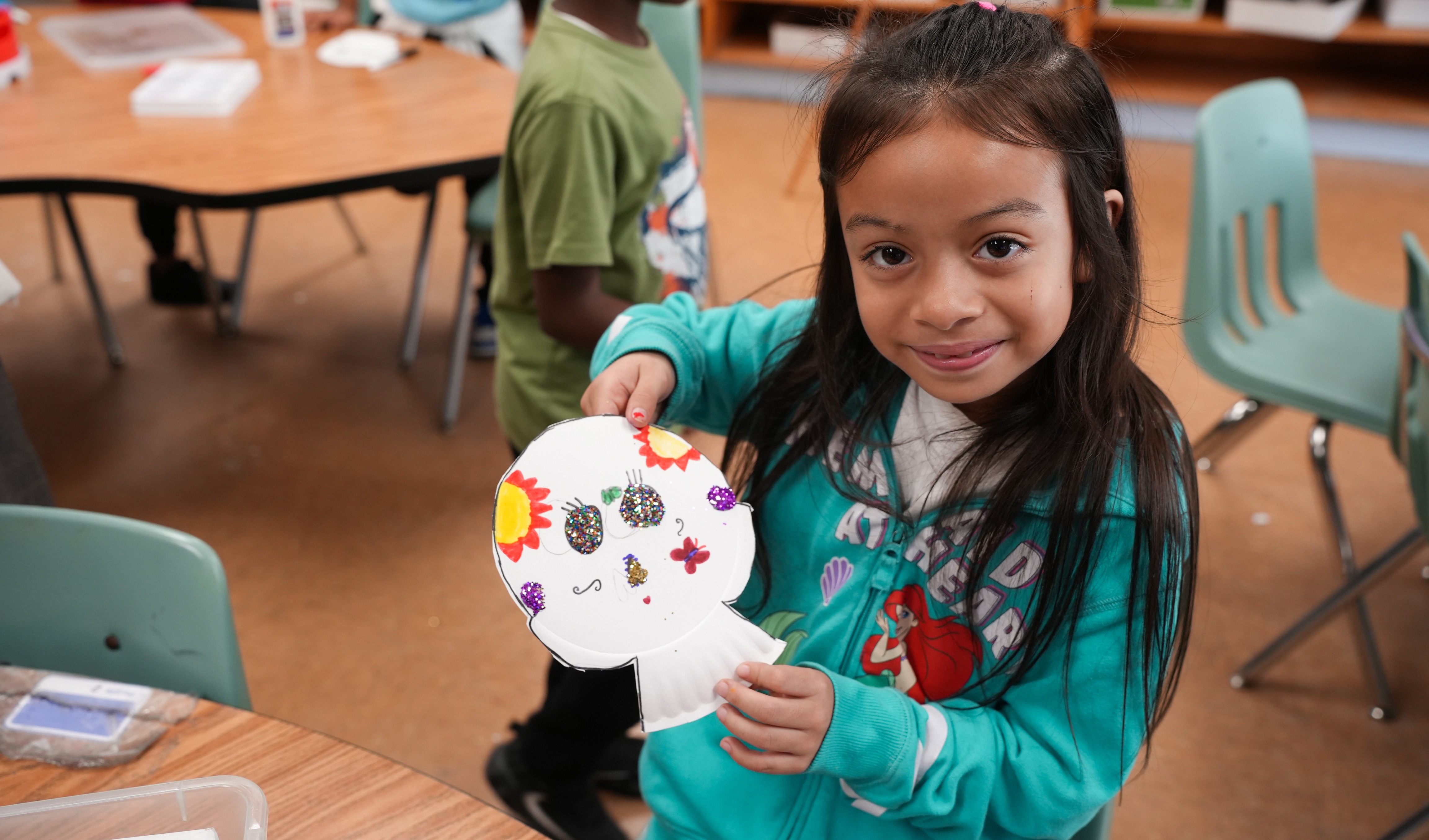 student doing craft activity with student