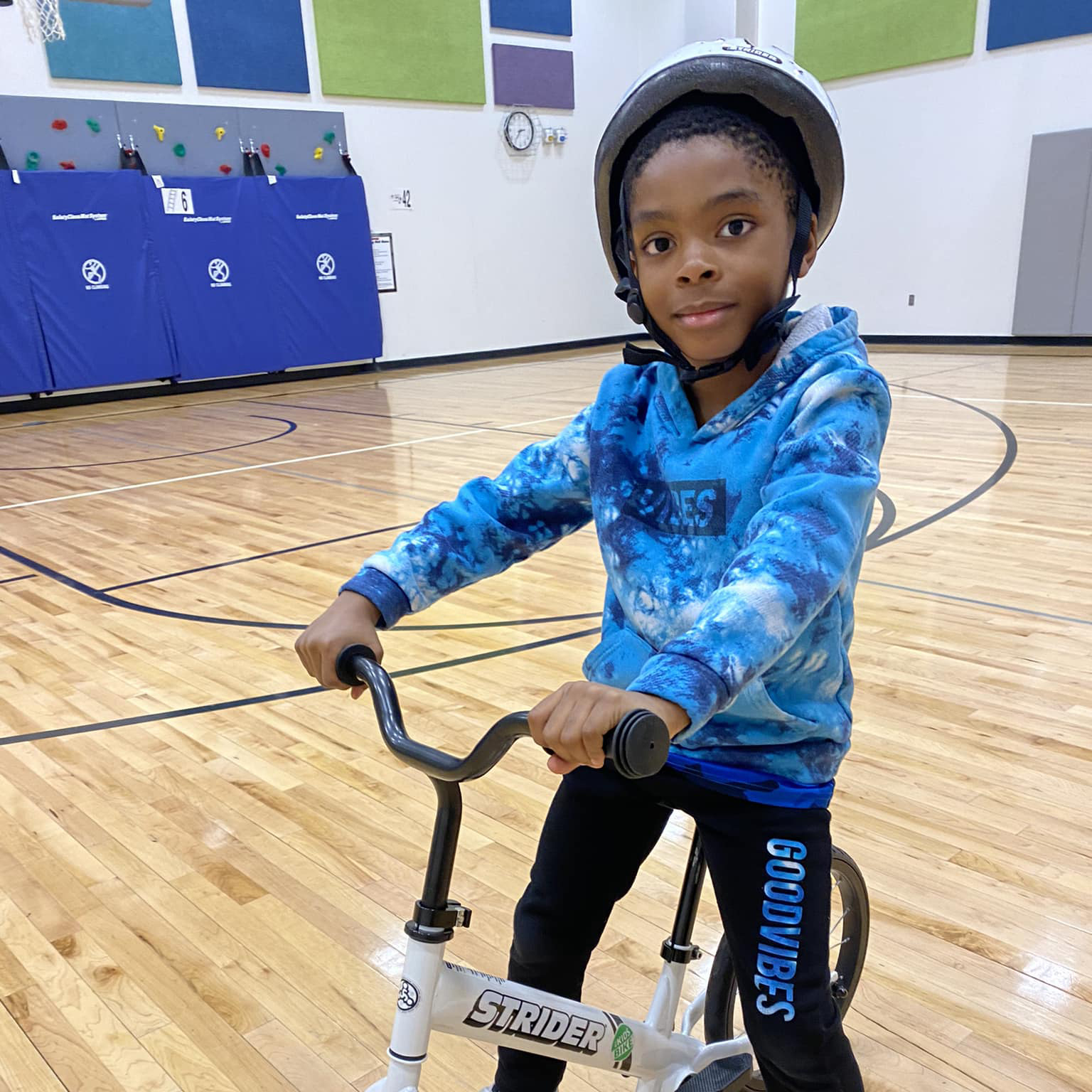 Student riding his bike in the gym