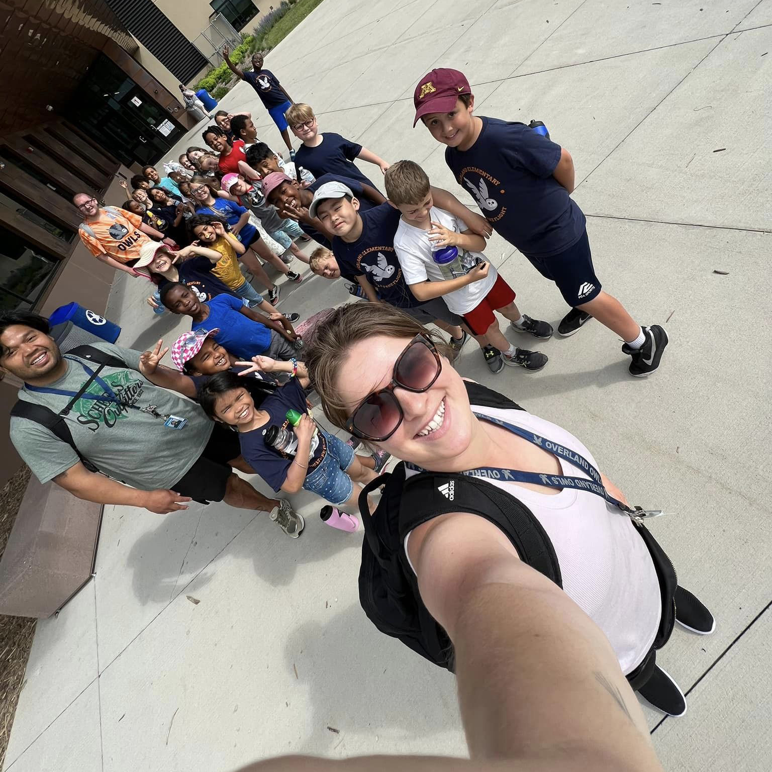 A teacher taking a selfie with her students