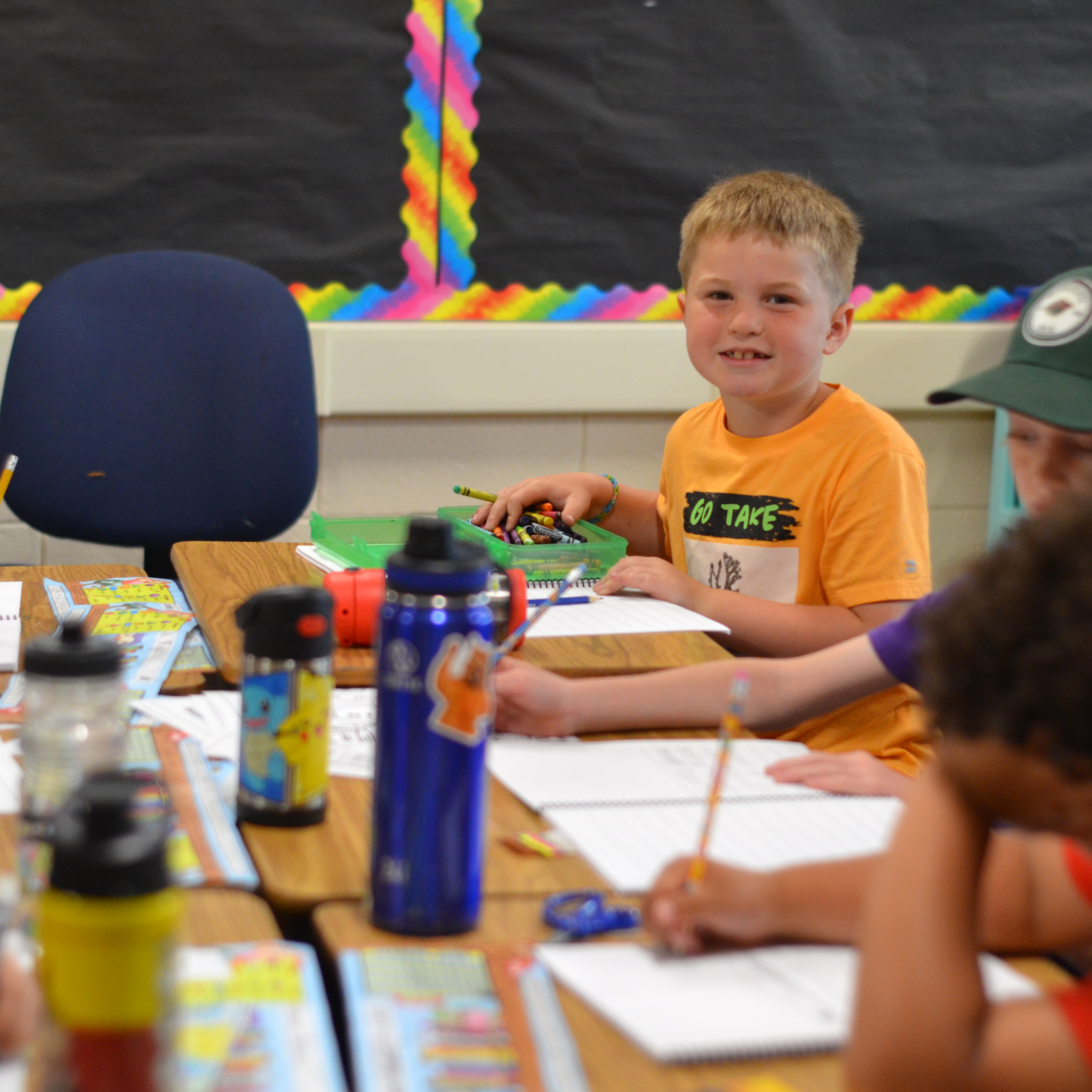 A student in the classroom, looking at the camera