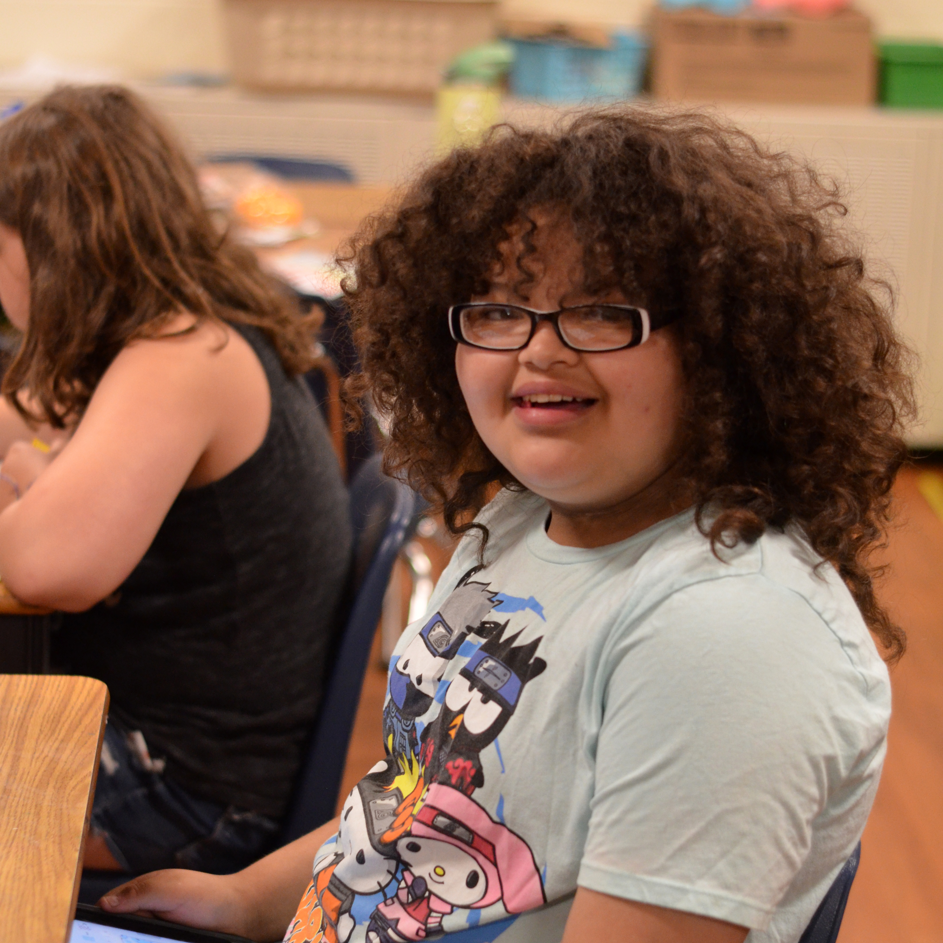 A student smiling brightly at the camera