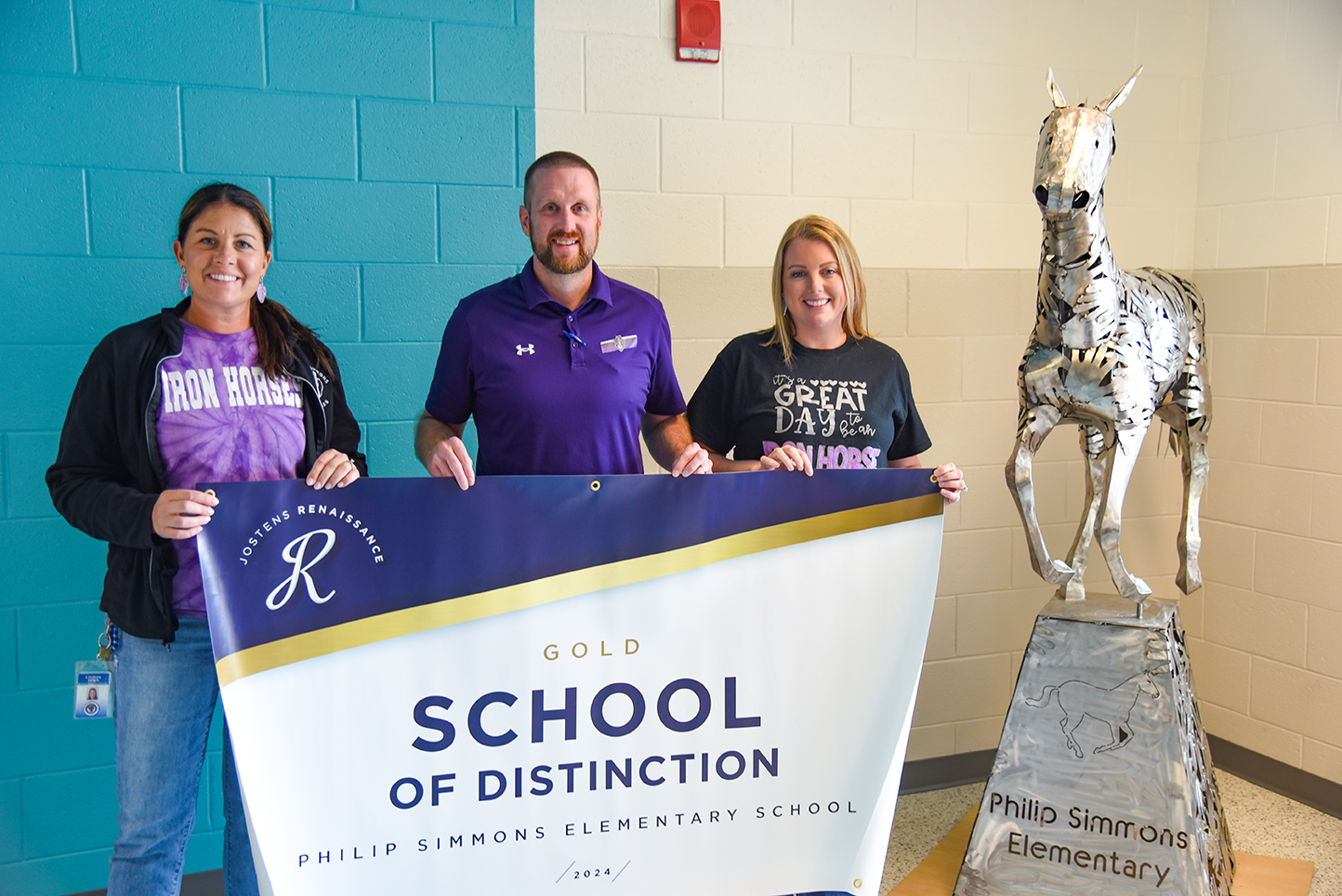 PSE admin with School of Distinction banner