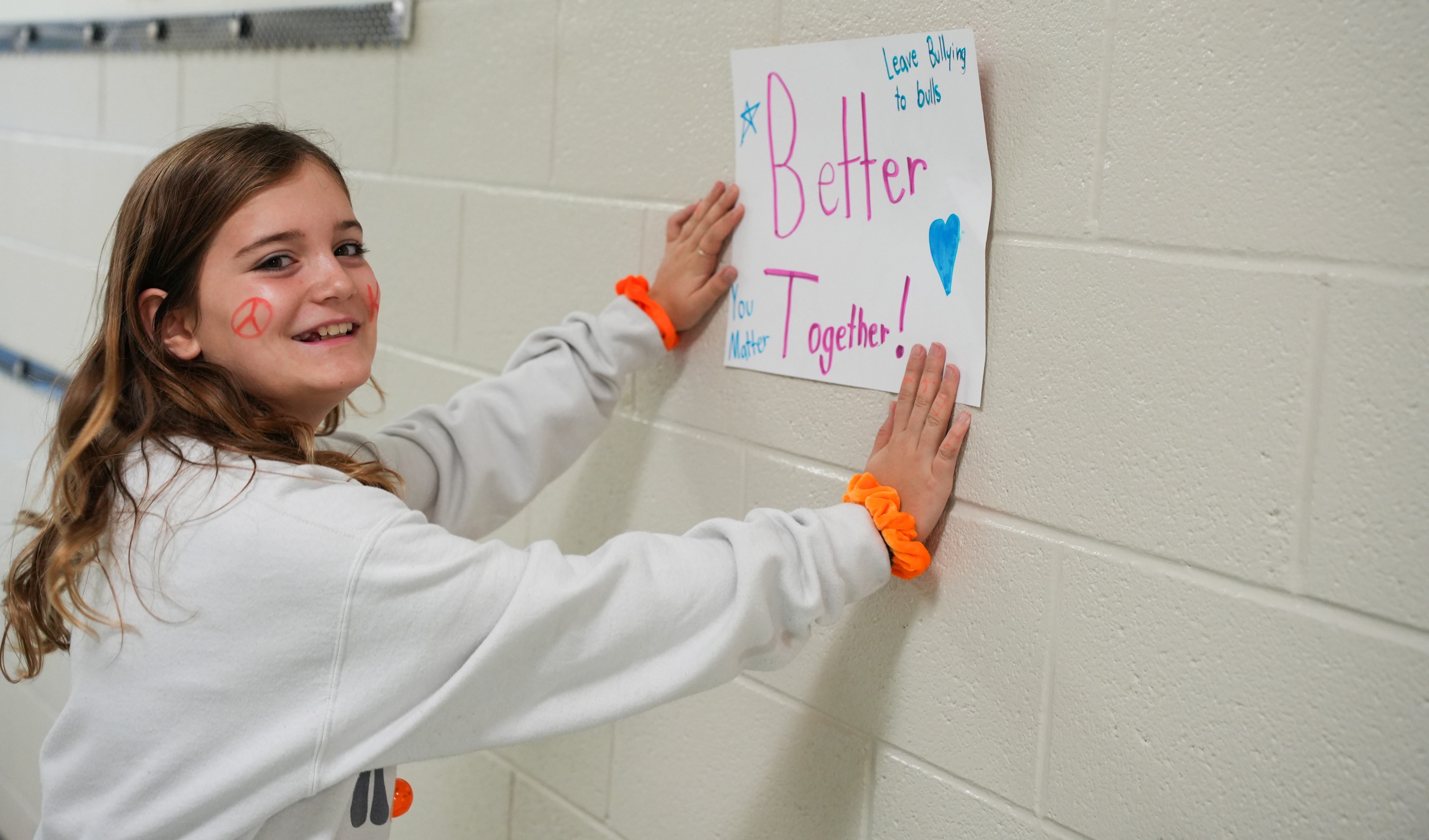 student putting up poster