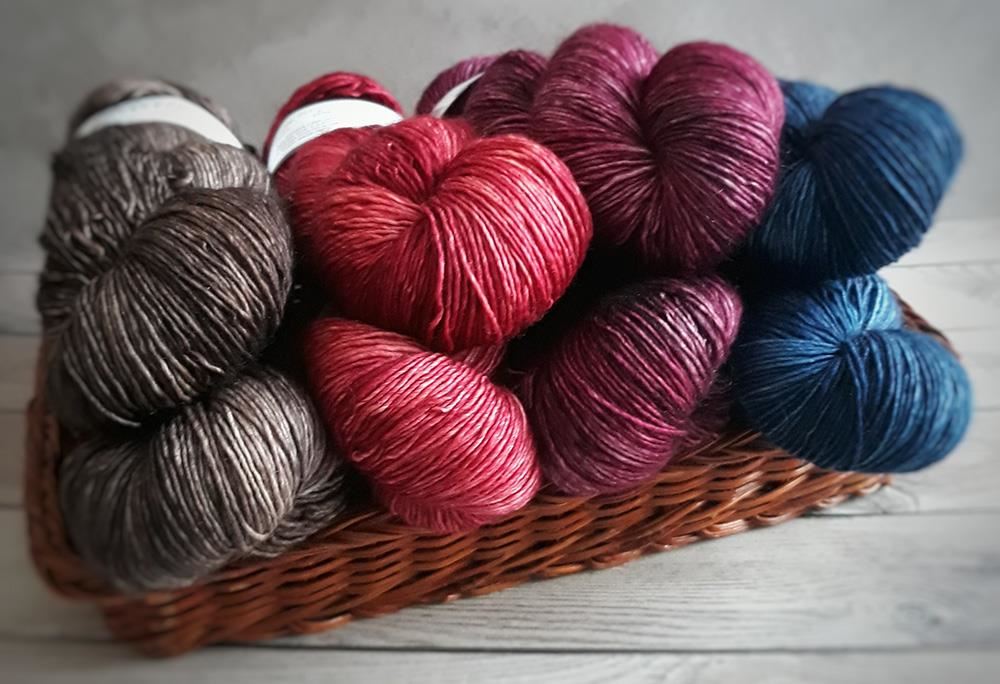 basket of red, brown, purple, and blue yarn