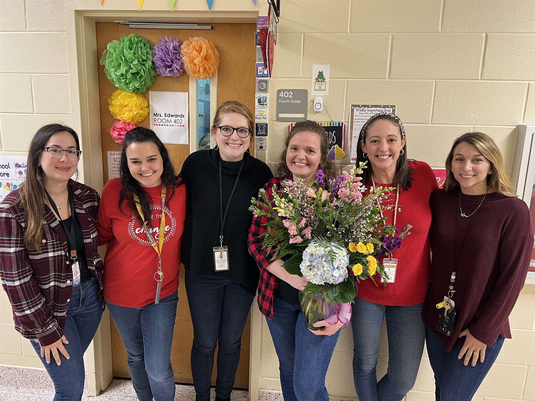 teacher of the year pose for photo with staff