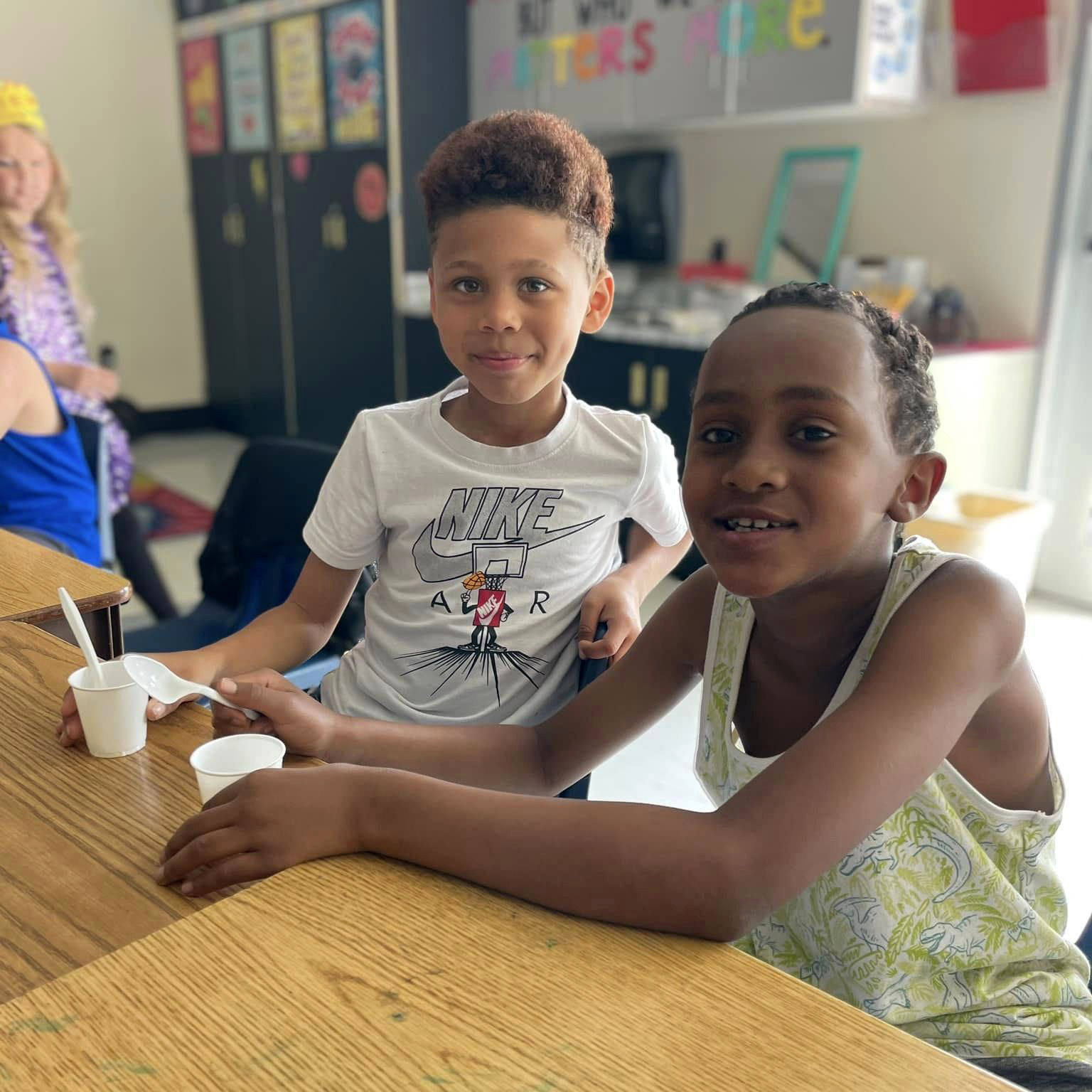 Two students smiling at the camera