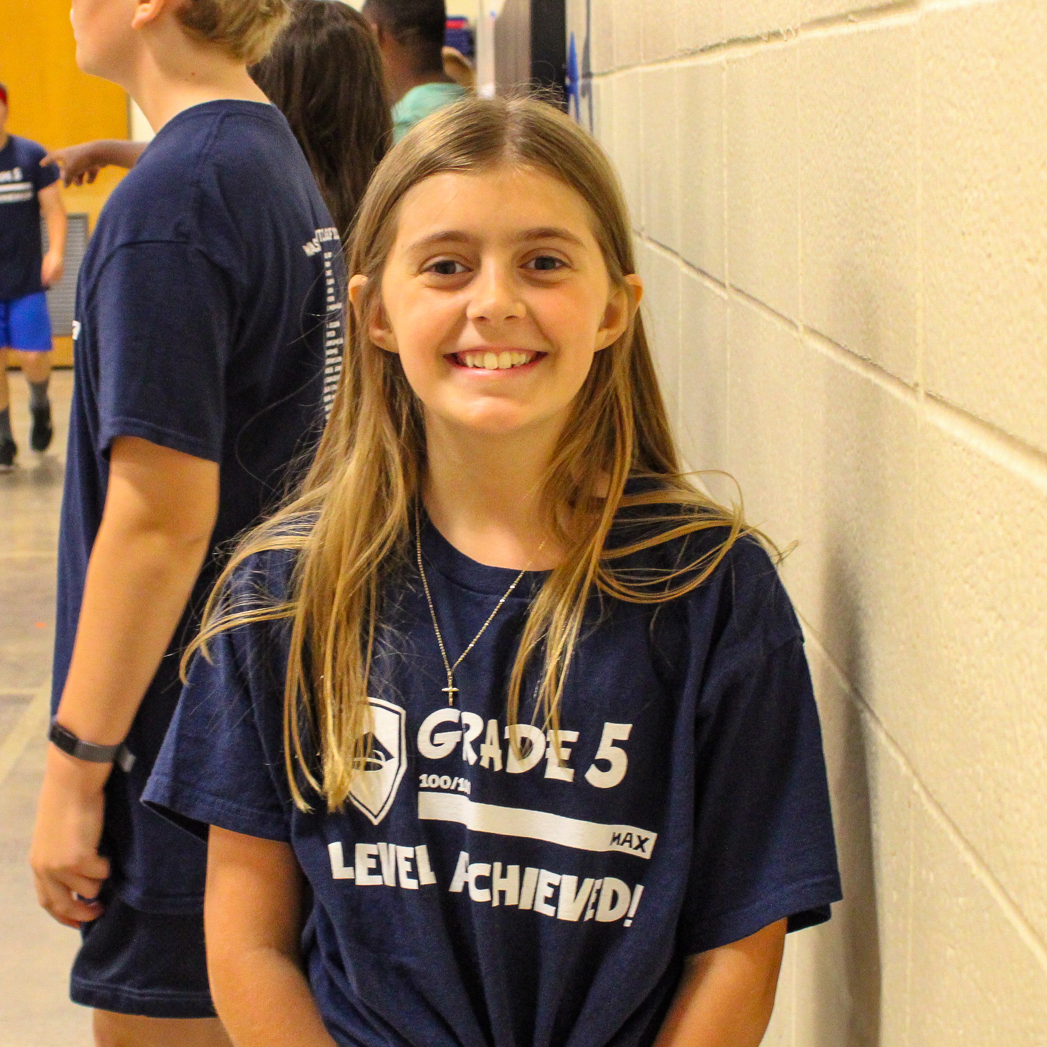 A student looking at the camera and smiling