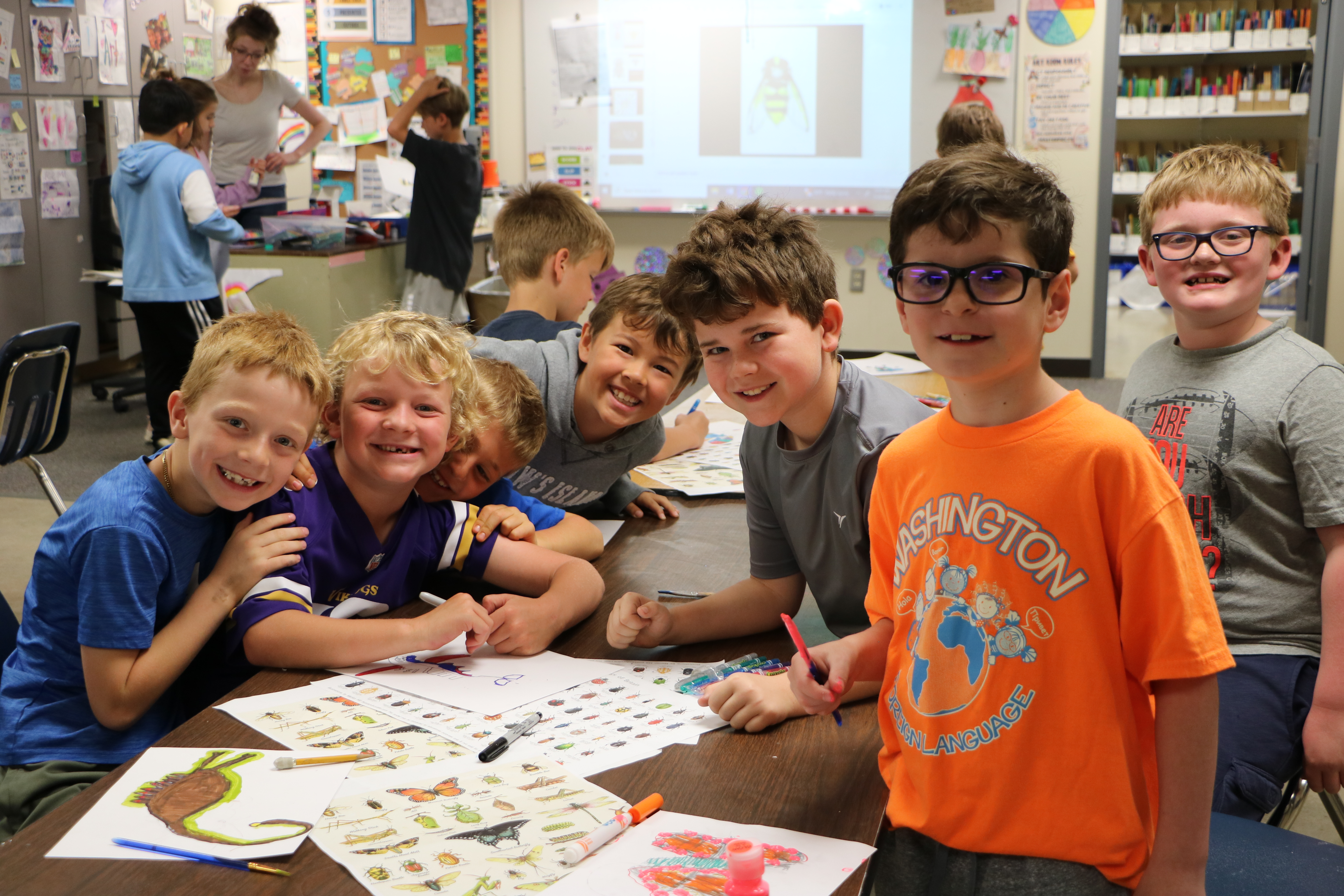 students in art class smiling at camera