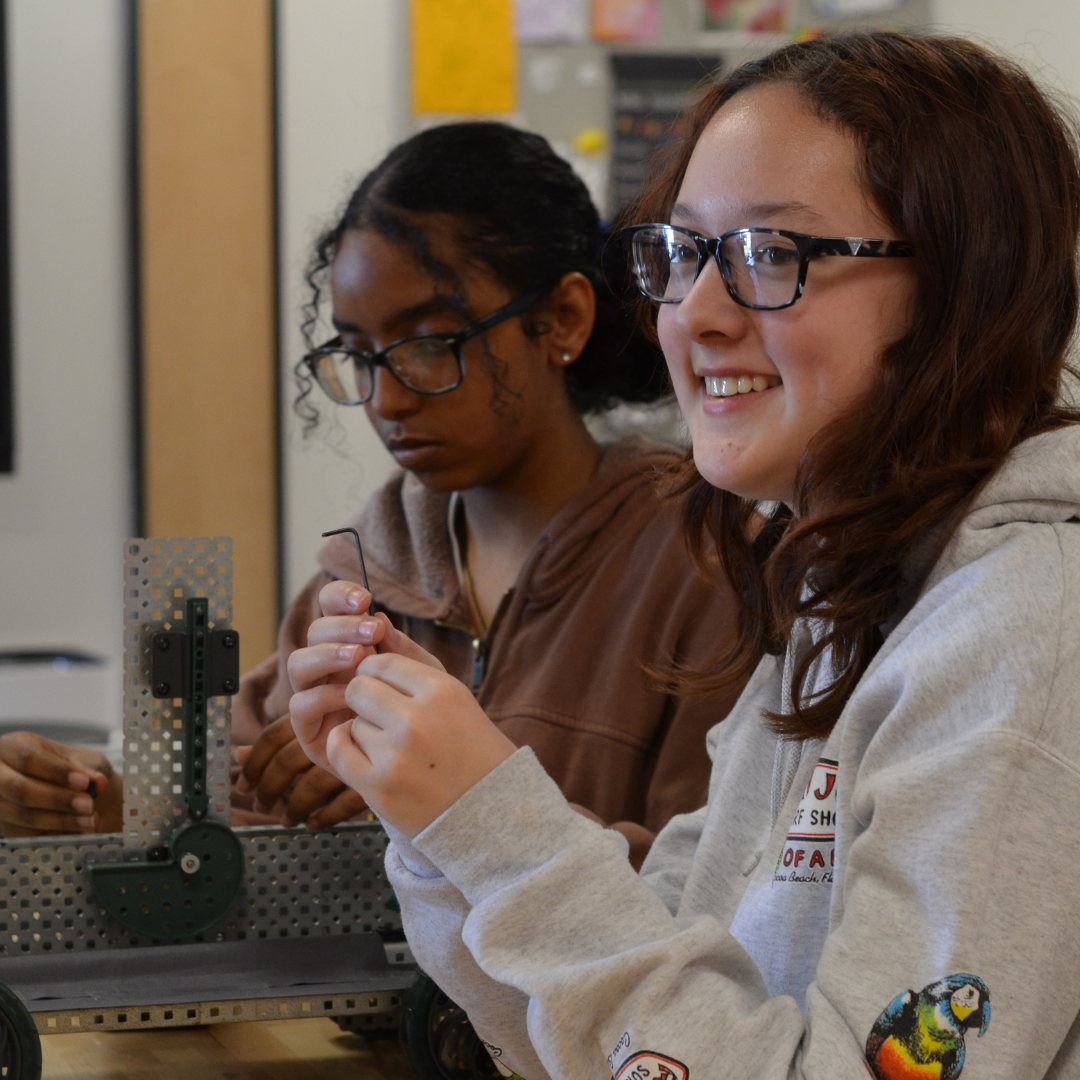 Two female dakota students building a robot in a STEM activity