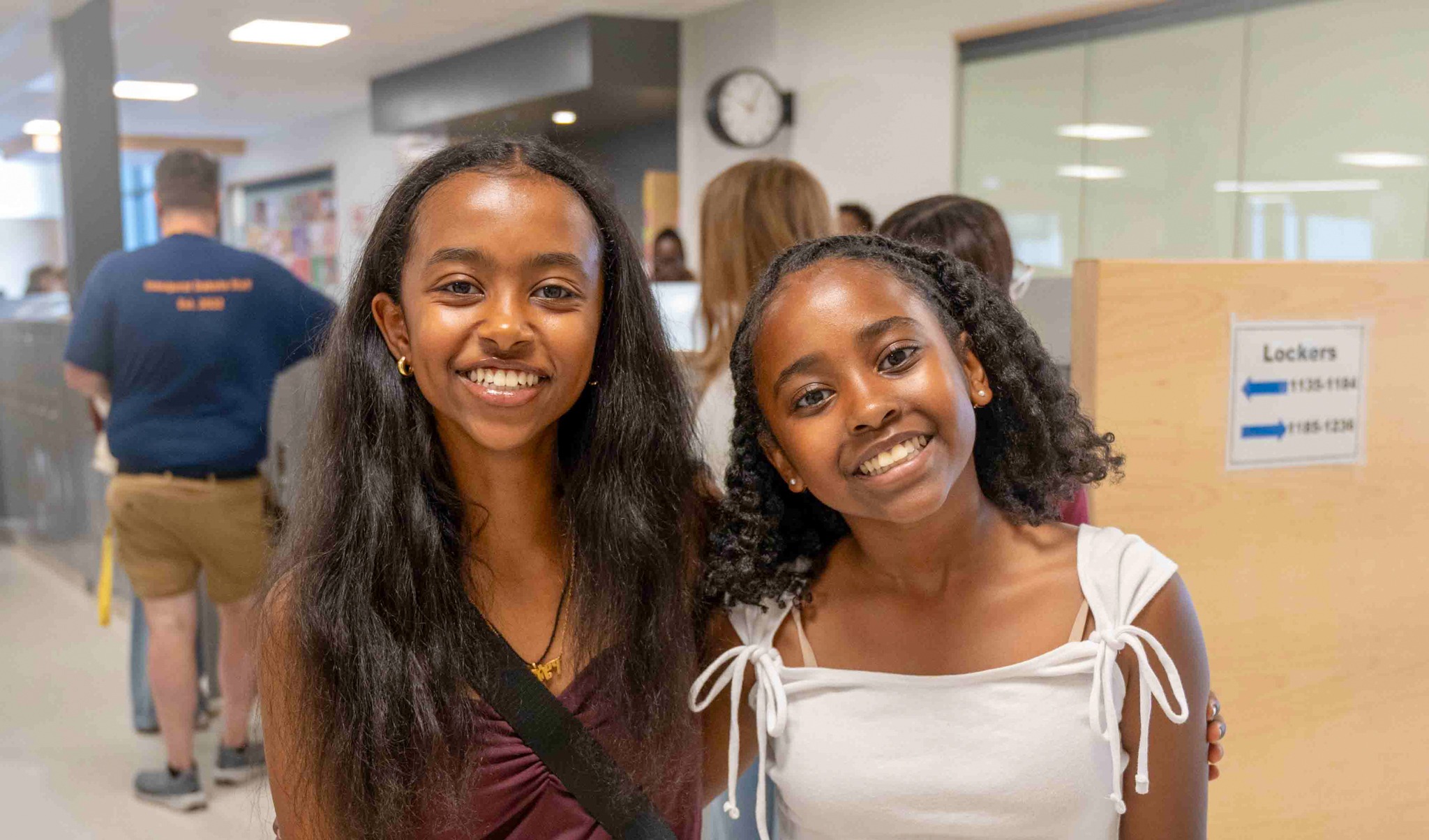 Two students smiling at the camera