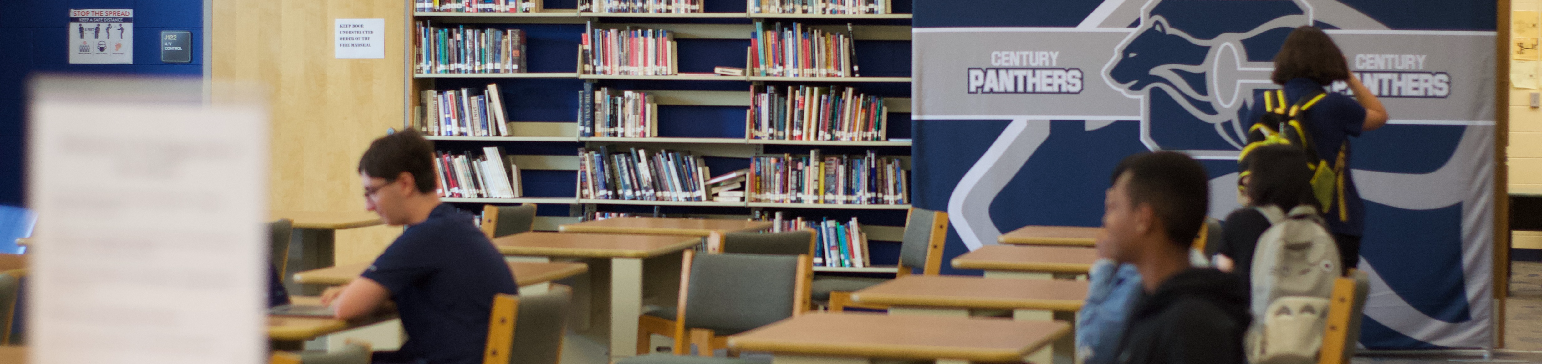 Students working at break out tables in the Century High School Library