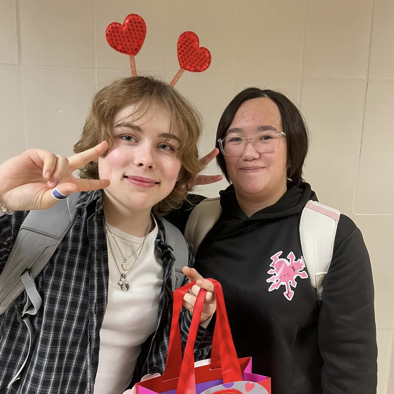 Two students with Valentine's day decor on