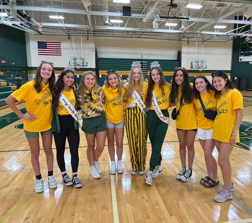 Students dressed in green and yellow in mayo gym.
