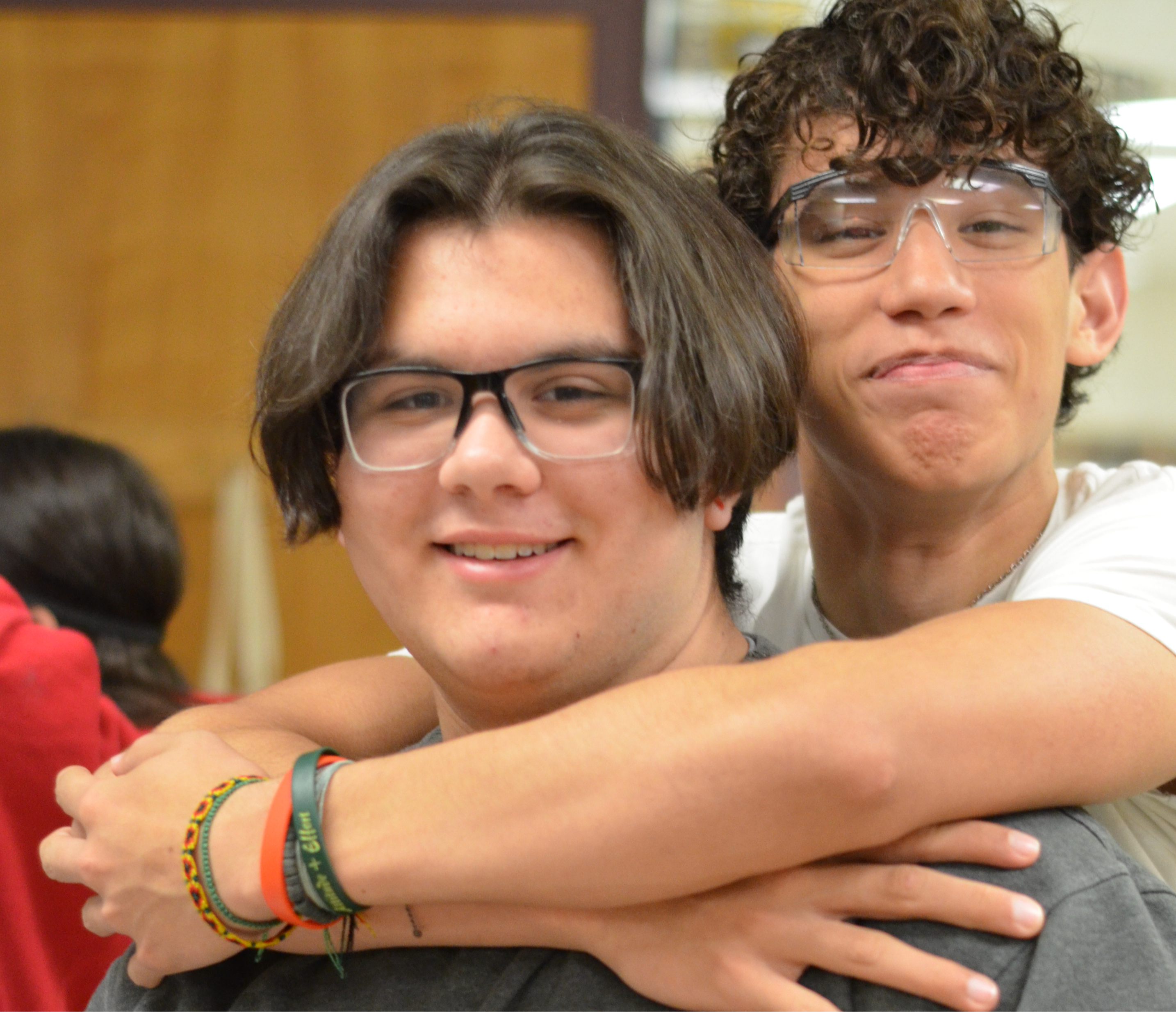 two male students smiling at camera in science lab