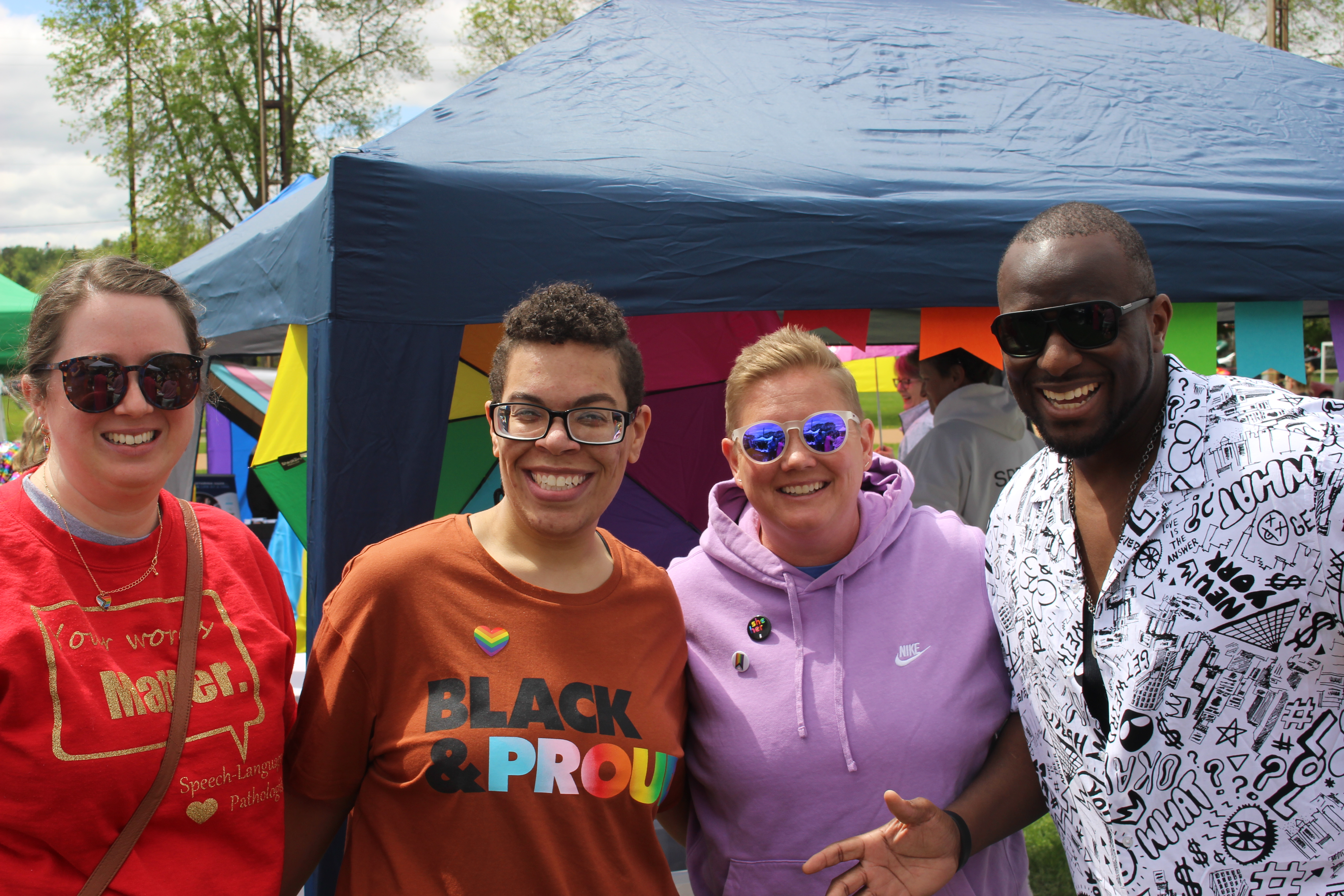 four smiling adults at Rochester Pride