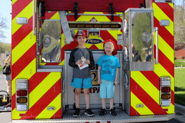 2 young boys on a fire truck