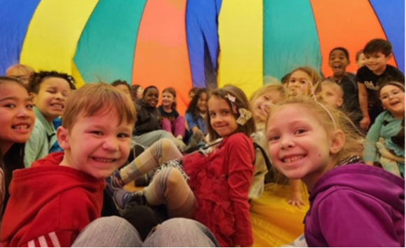 SACC children under a parachute