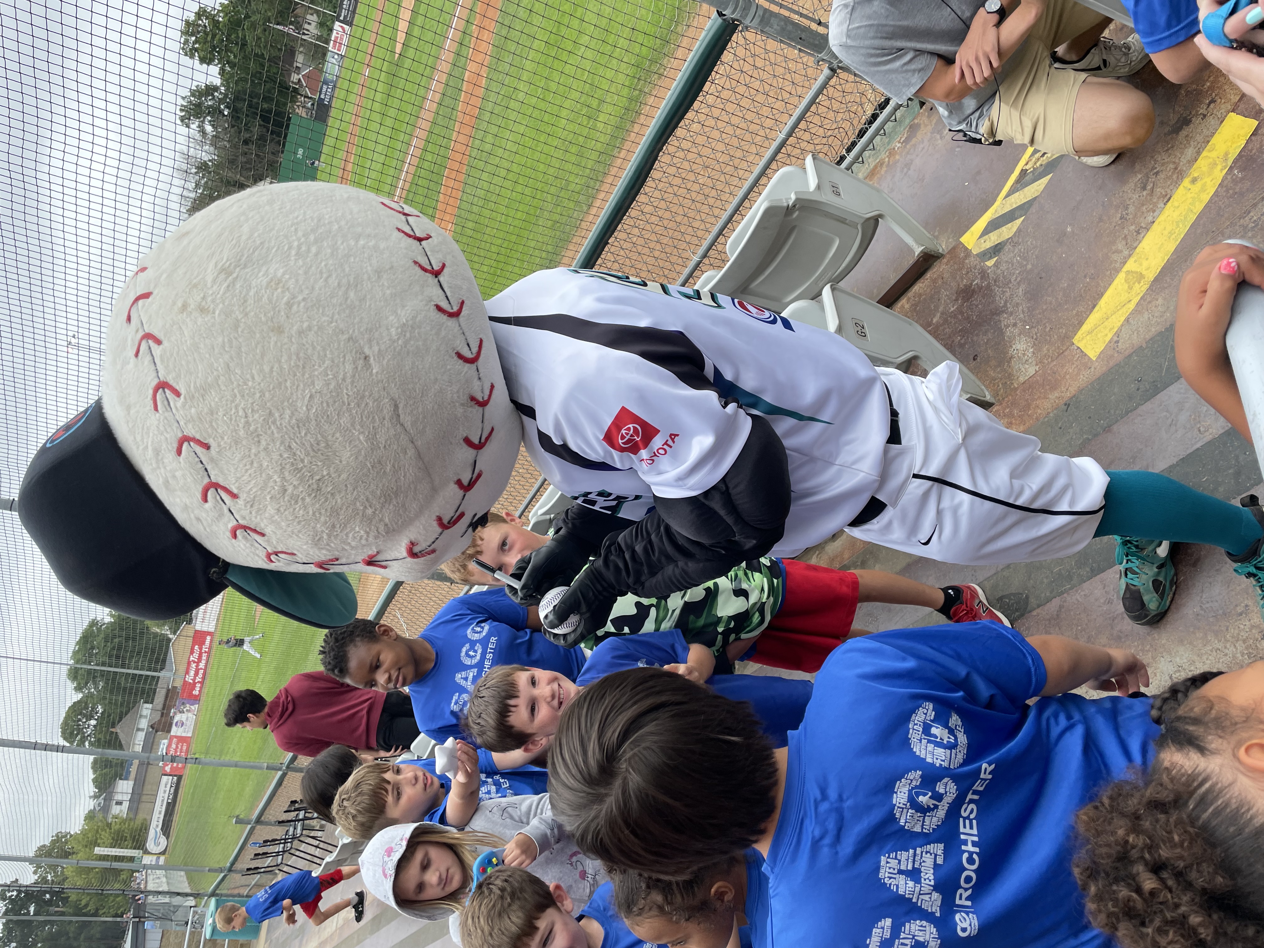 SACC children at a Honkers game, Slider signing a ball